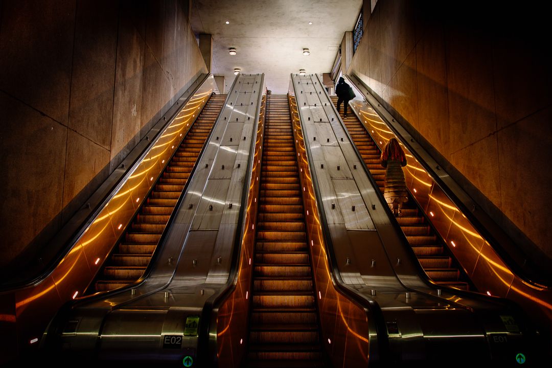 Illuminated escalators inside Metro Center station in Washington, D.C.