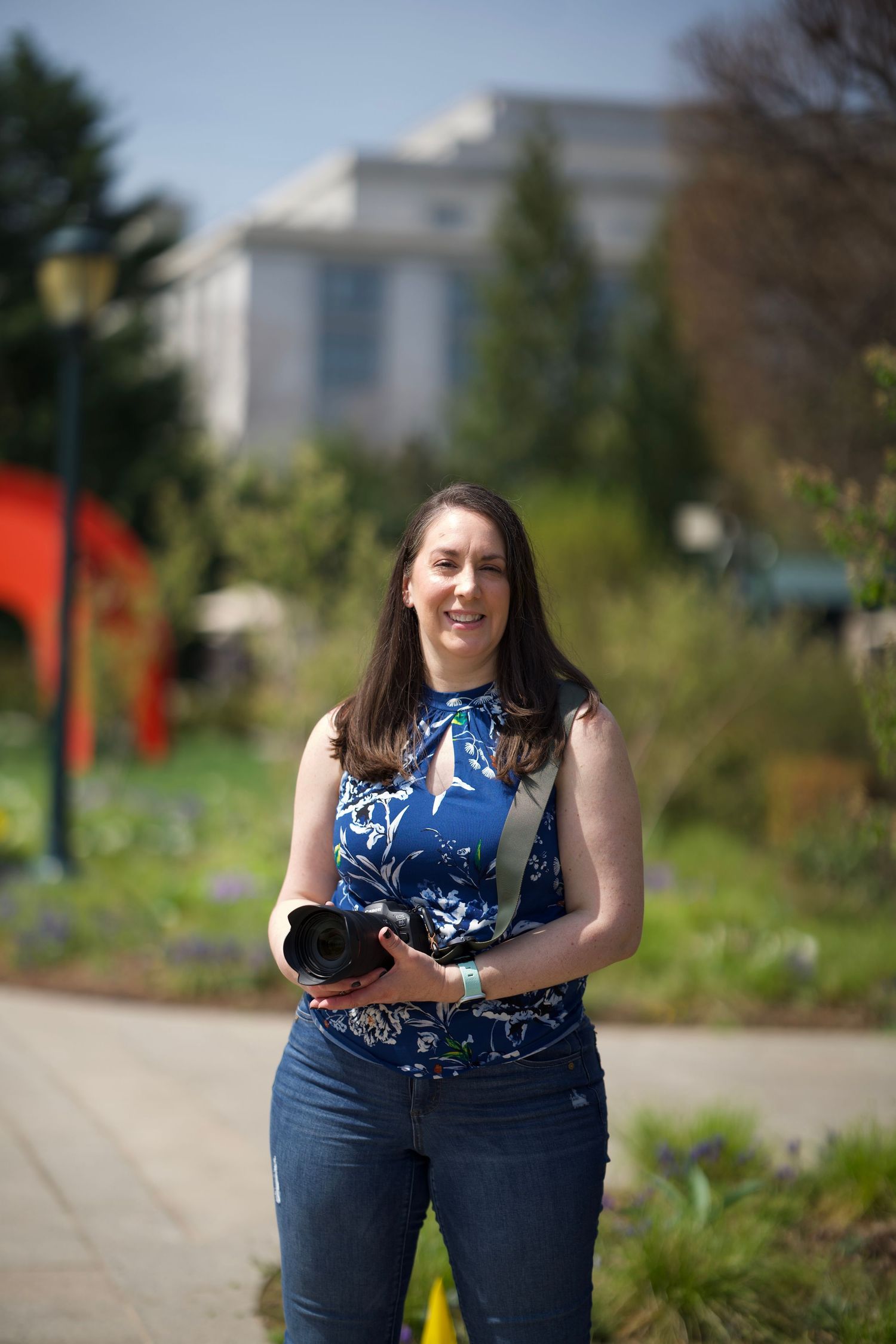 Photographer Sarah standing outdoors with her camera