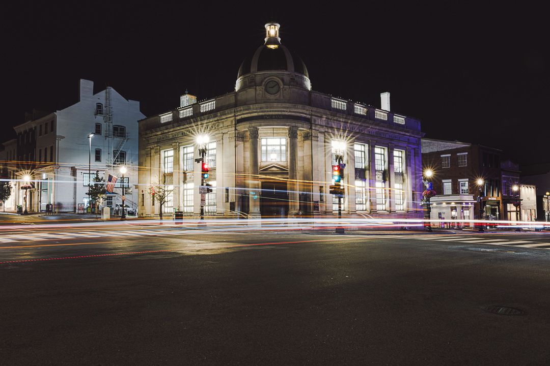 Historic PNC Bank building illuminated at night in Georgetown, Washington, D.C.