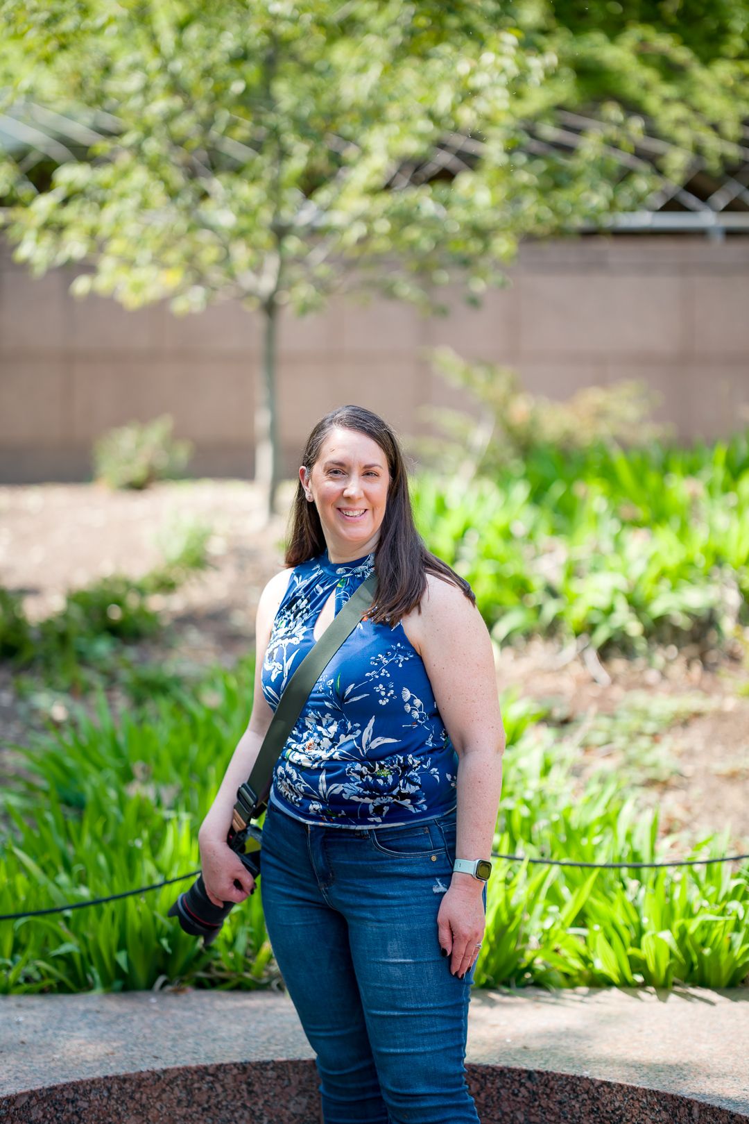 Photographer Sarah standing outdoors with her camera
