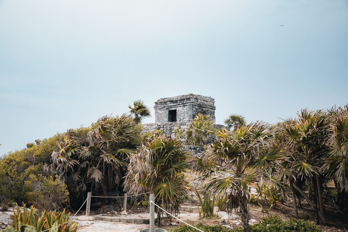 Mayan ruin surrounded by tropical vegetation at Tulum, Mexico