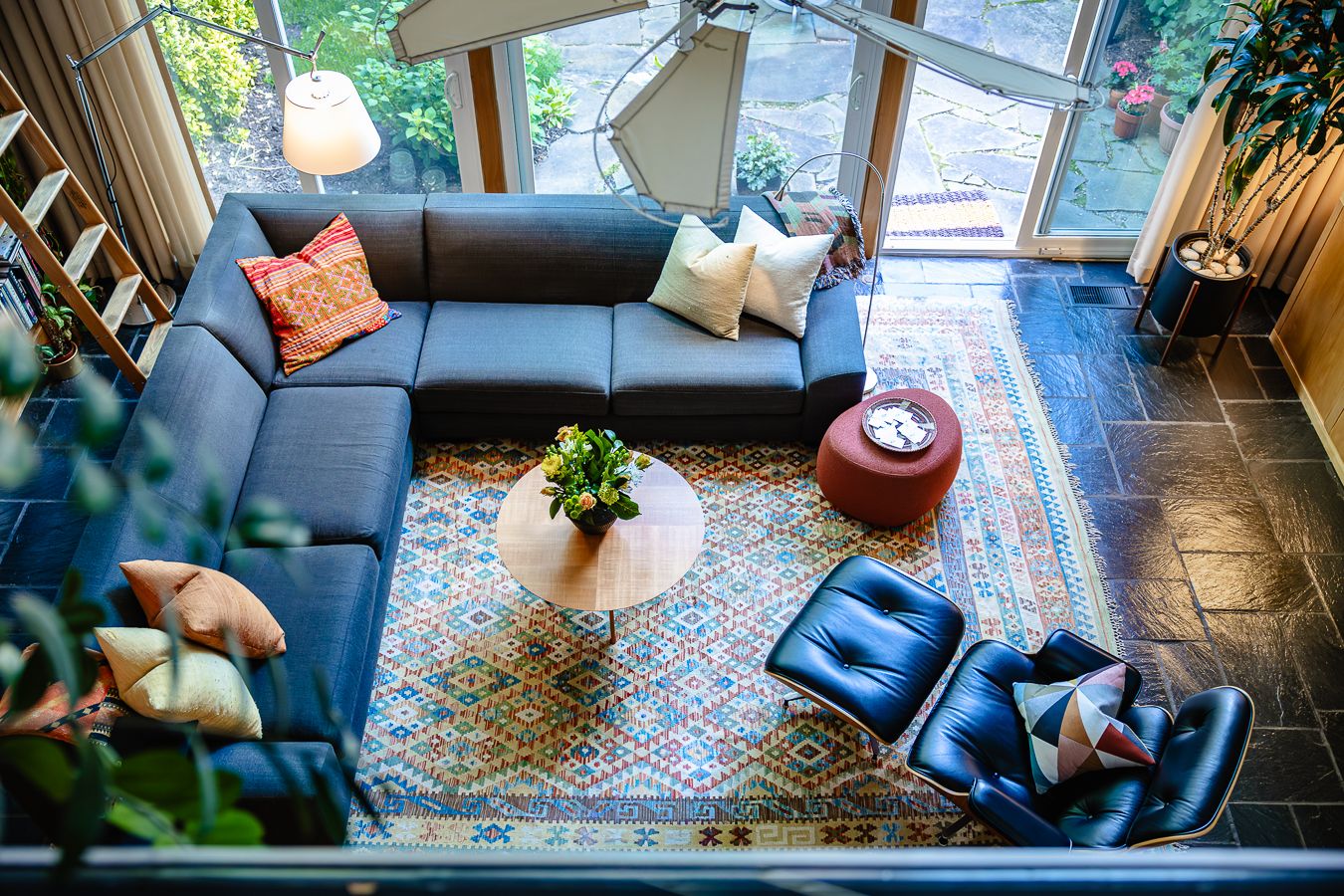 Mid-century modern living room with large windows and colorful furnishings