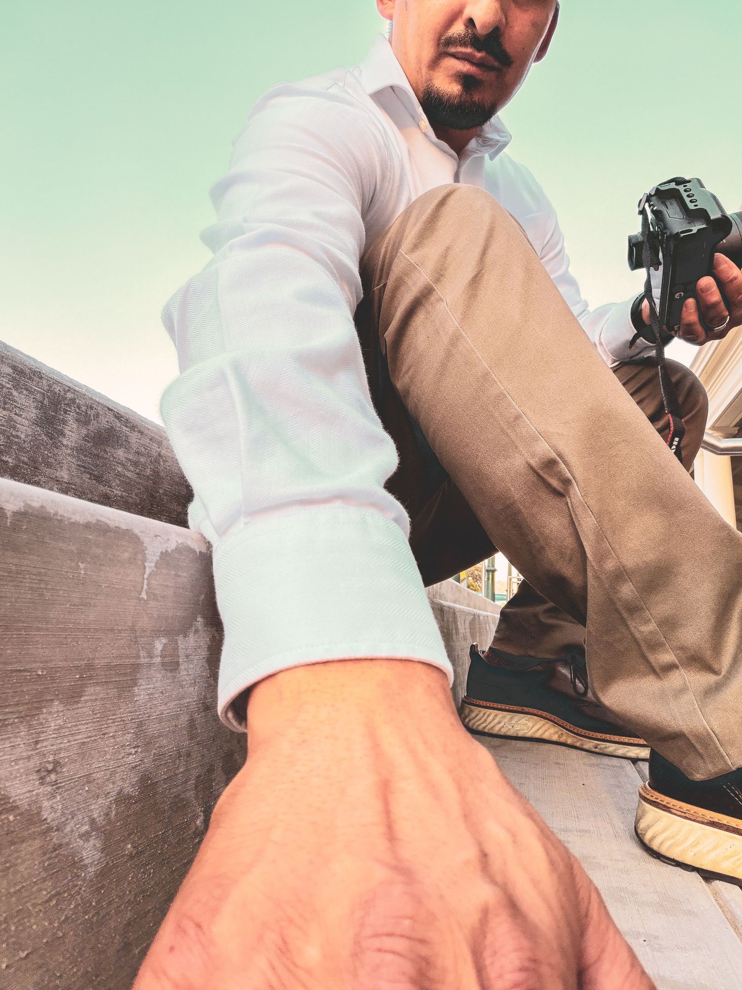 Upward photo of a man reaching for a phone