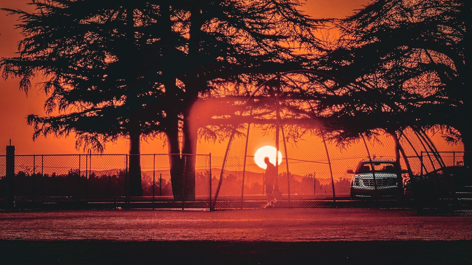 Inland Empire sunset at a park with a male silhouette in the background.