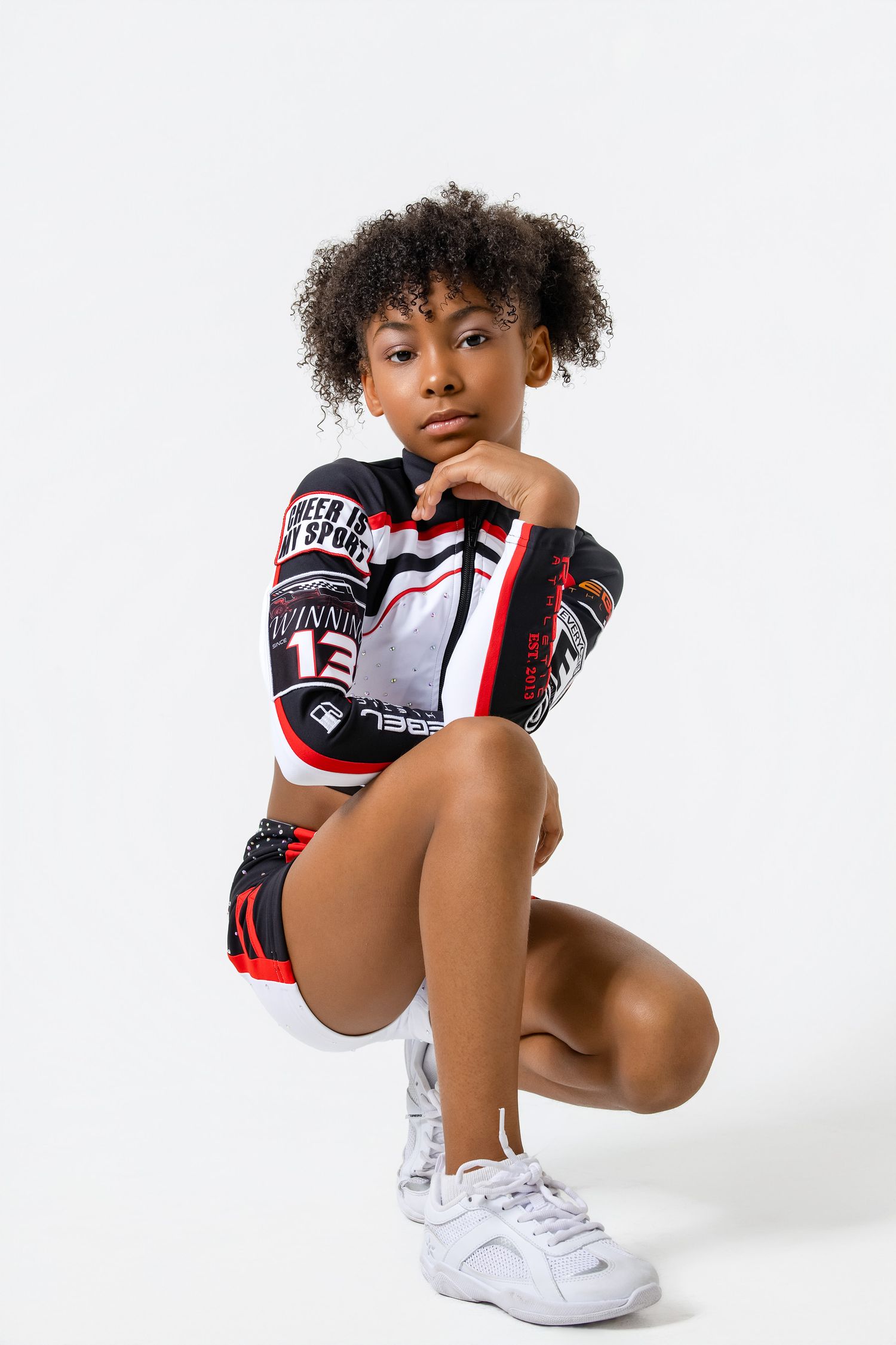 Athletic model wearing boxing gloves and white sneakers poses in dynamic crouching positions against white background.