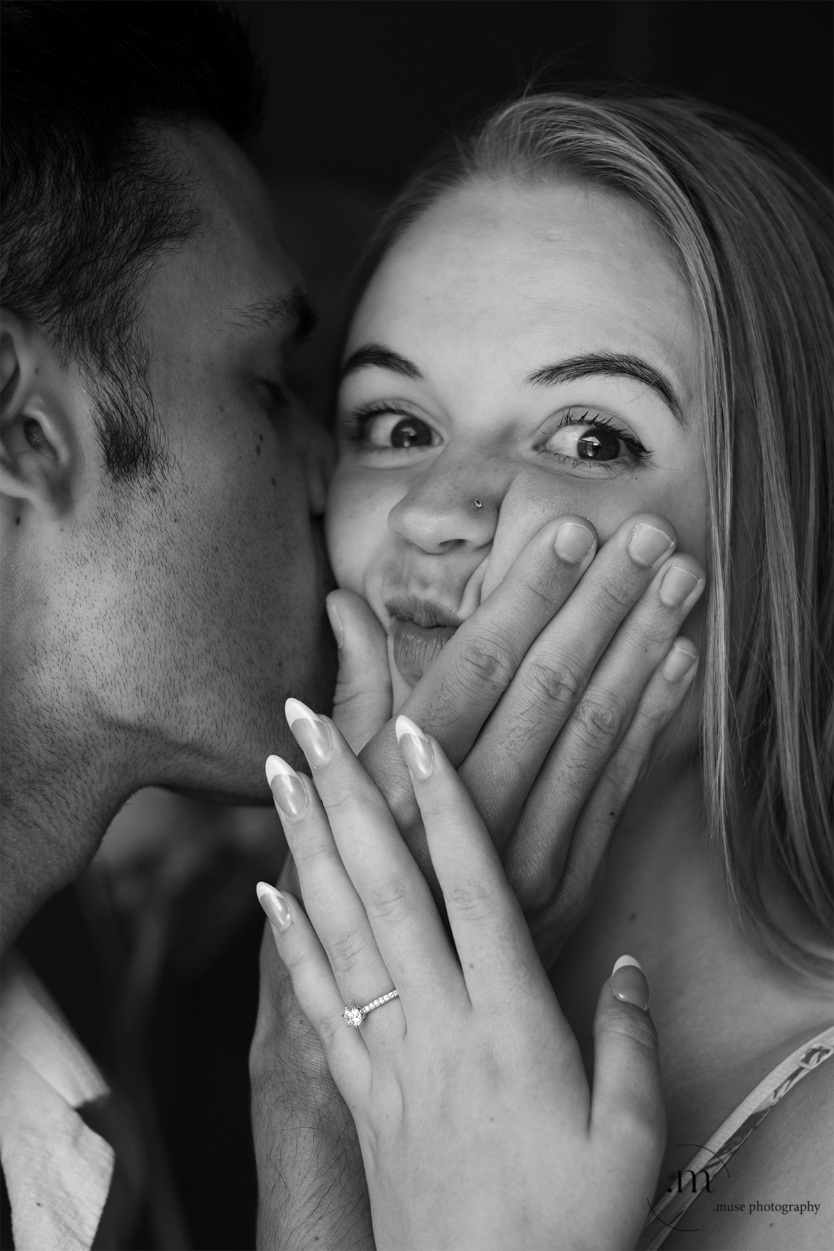 Husband squeezing wife’s face in black and white