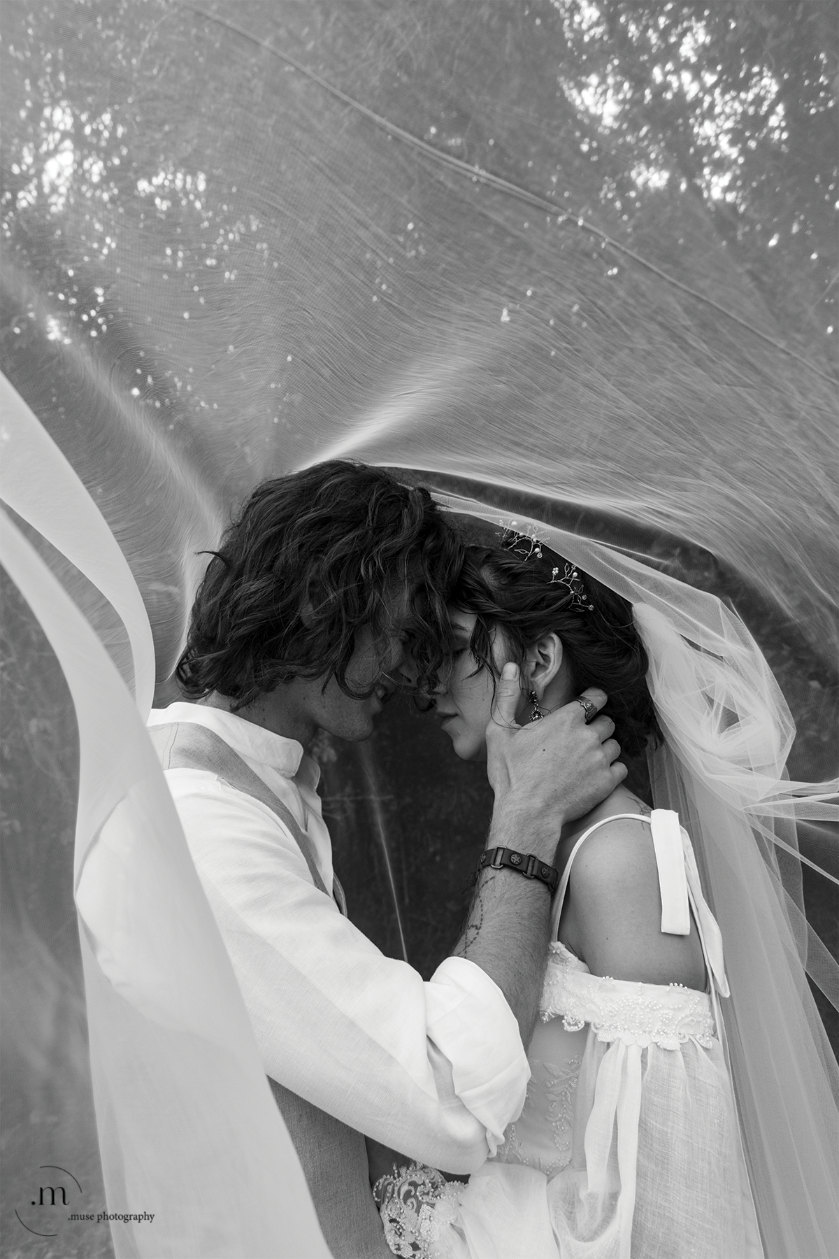 Bride and groom under the veil in black and white