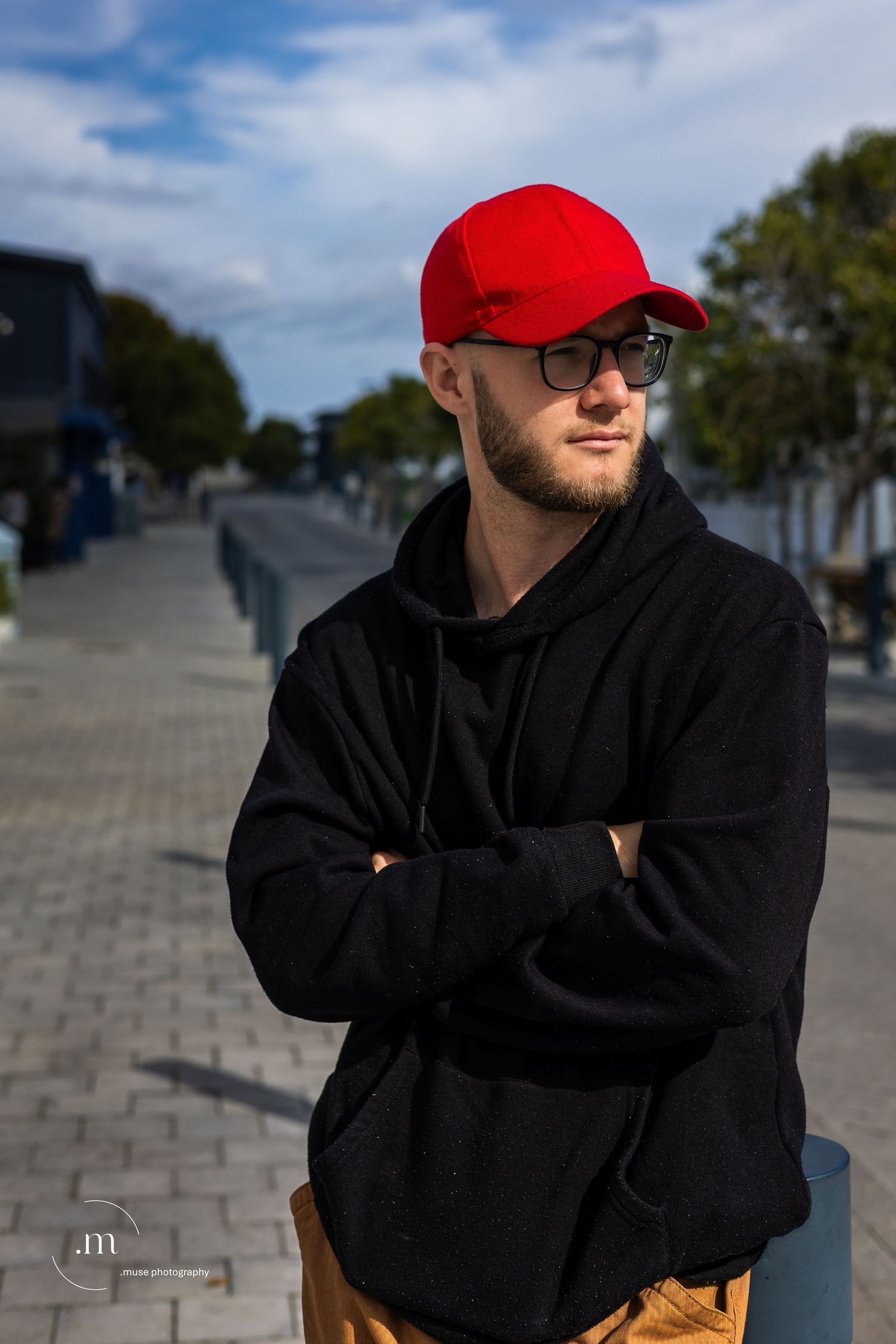 Black hoodie and red cap portrait