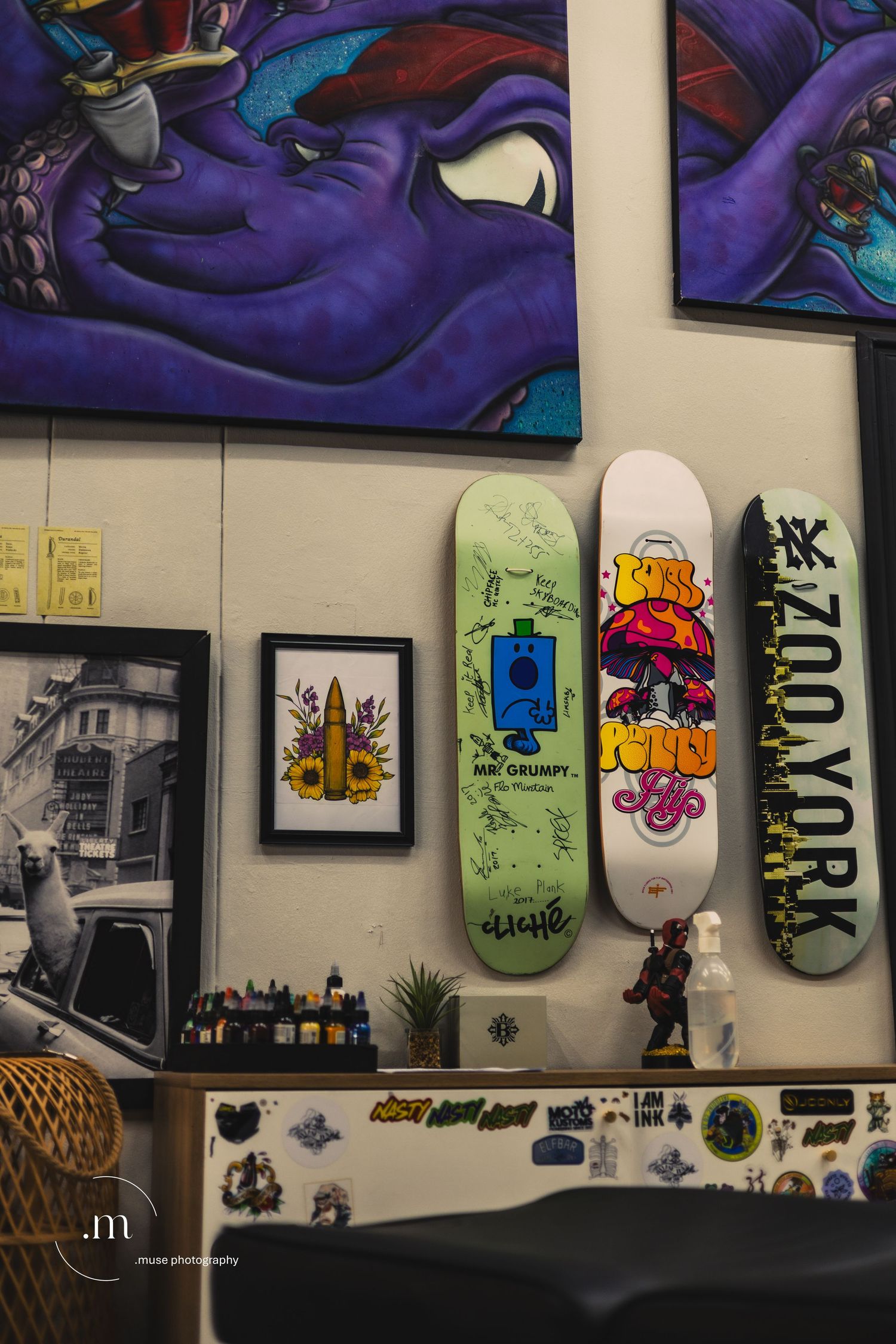 Wall filled with colorful artwork inside a creative studio