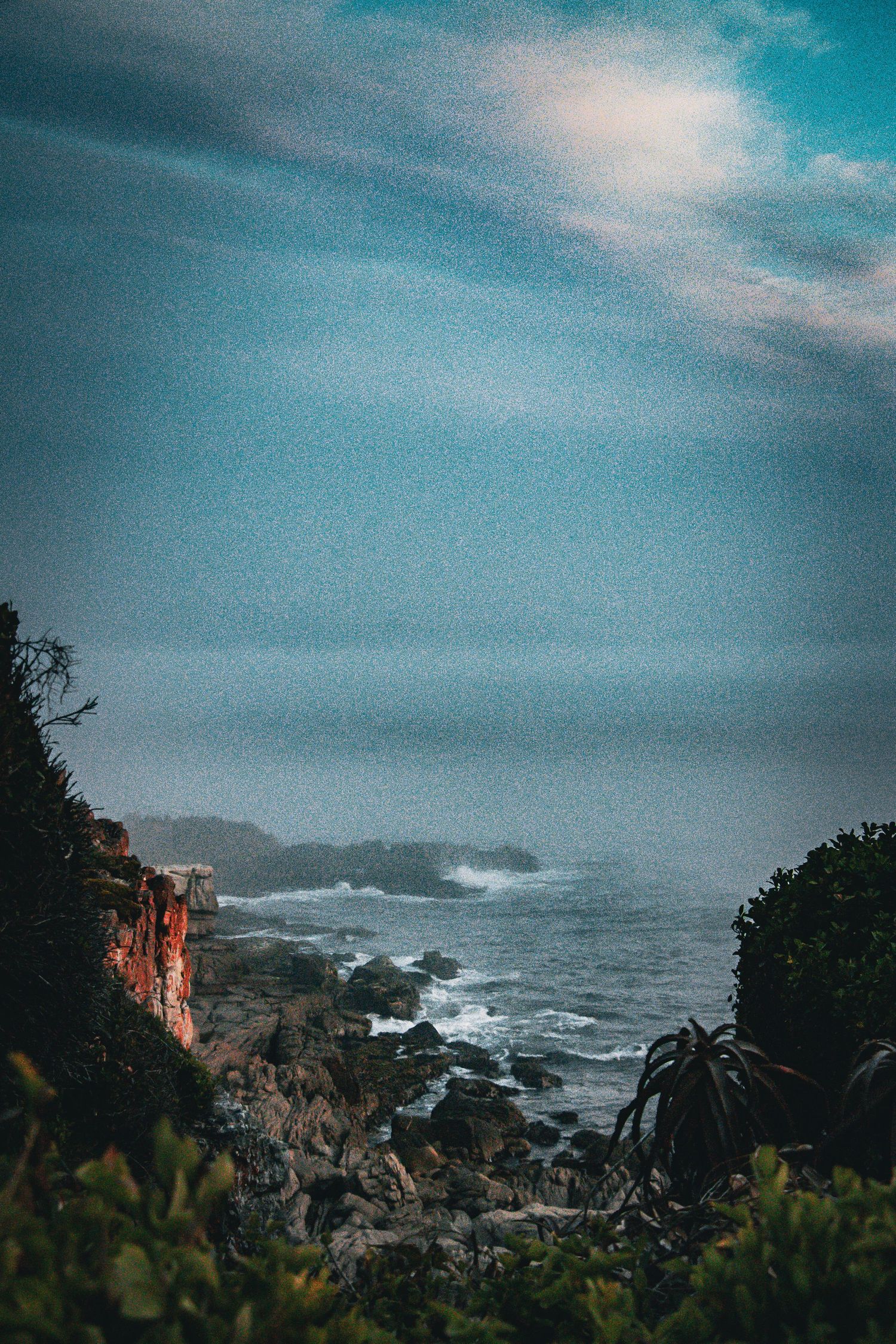Moody coastal landscape overlooking the ocean at dusk