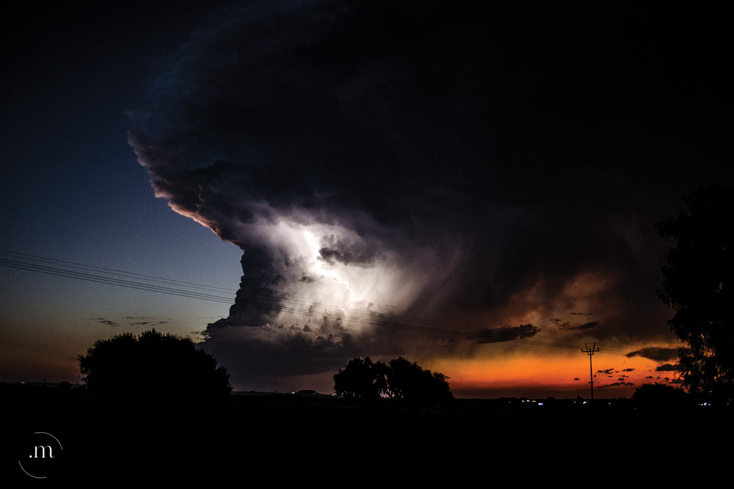 Lightning storm forming dramatic clouds over the landscape