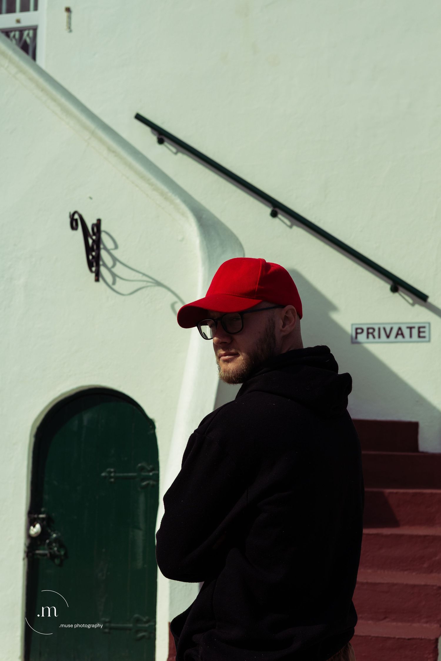 Black hoodie and red cap portrait with shades of green