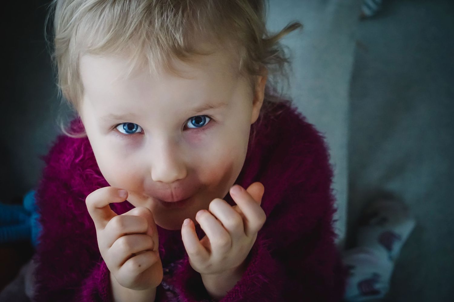 Close-up portrait sequence showing playful expressions in moody lighting.