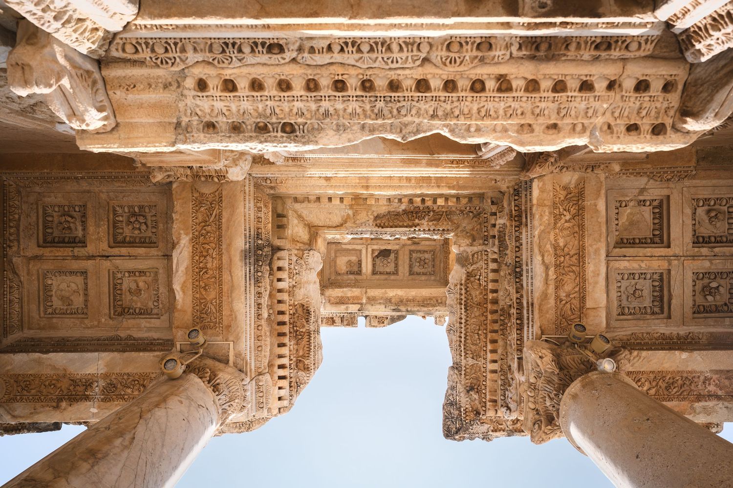 Detailed view of ornate classical architecture with carved stone patterns and columns.