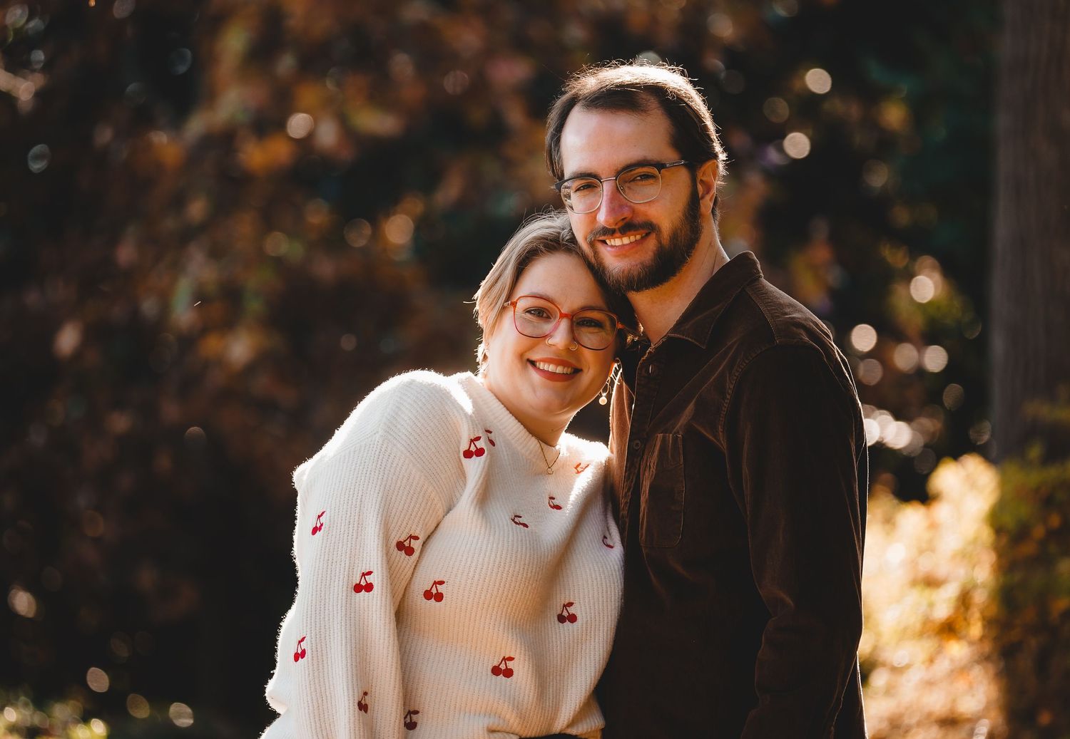A couple shares tender moments during an autumn sunset photoshoot.