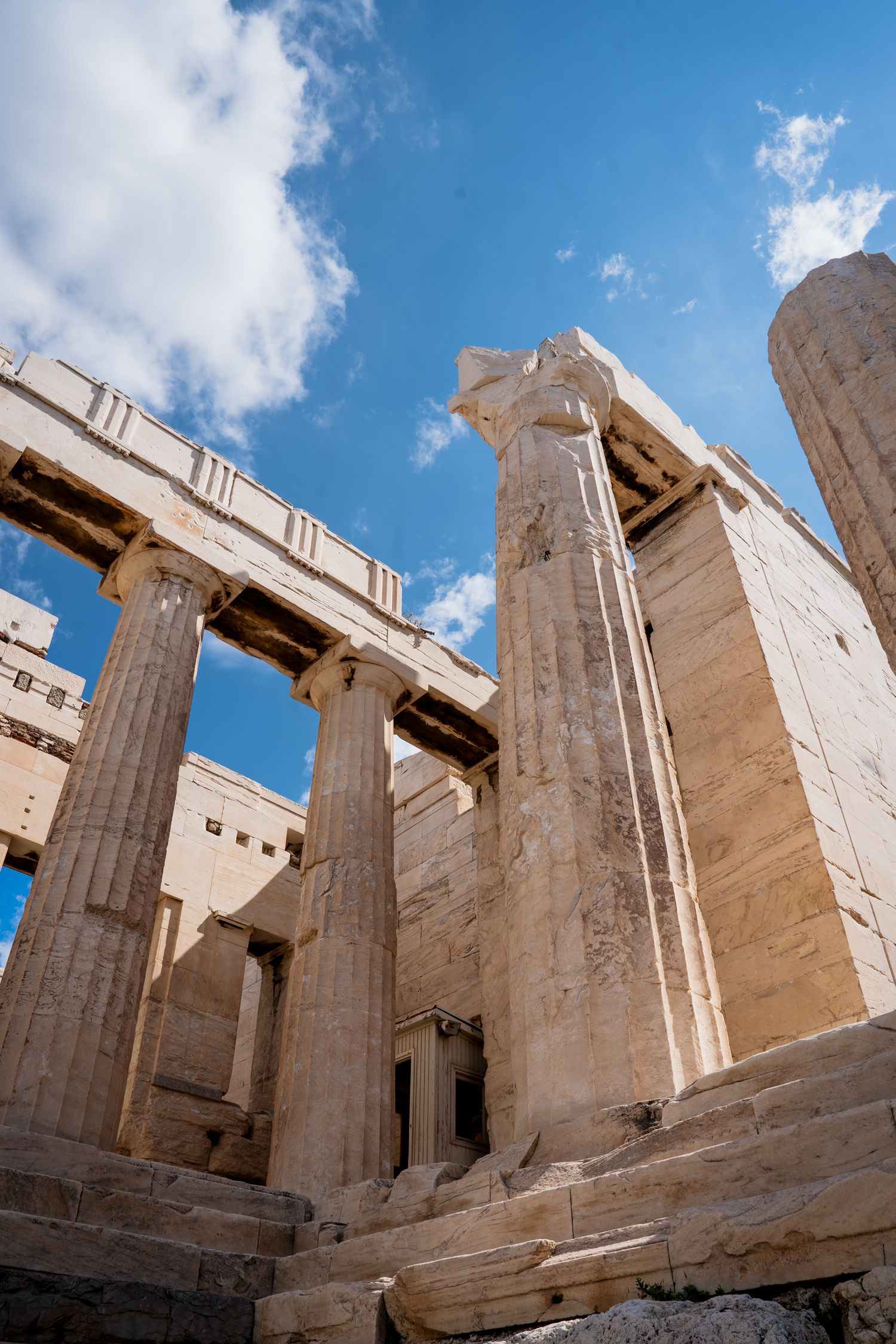 Ancient Greek columns of the Acropolis against blue sky in Athens.