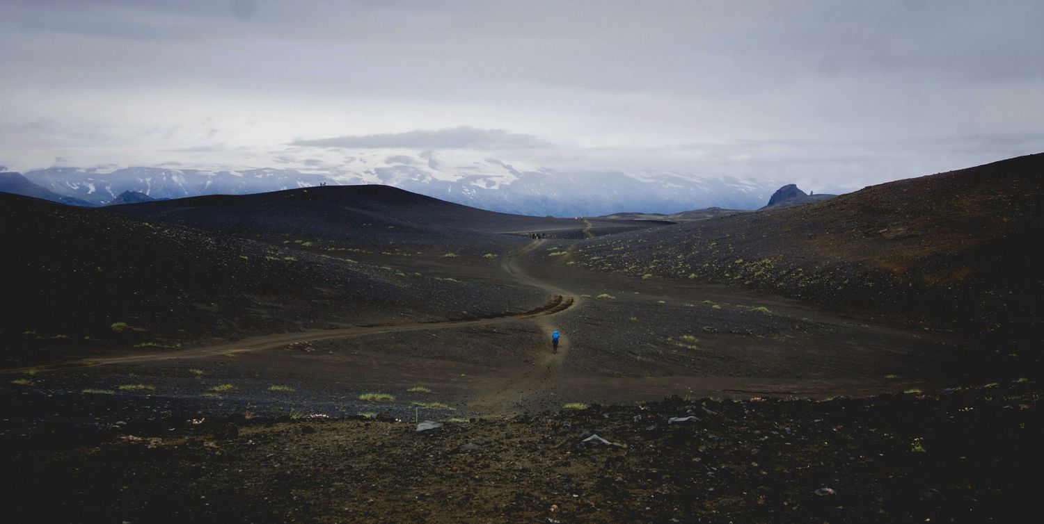 Panoramic view of rolling hills and mountains stretching across a vast wilderness landscape.