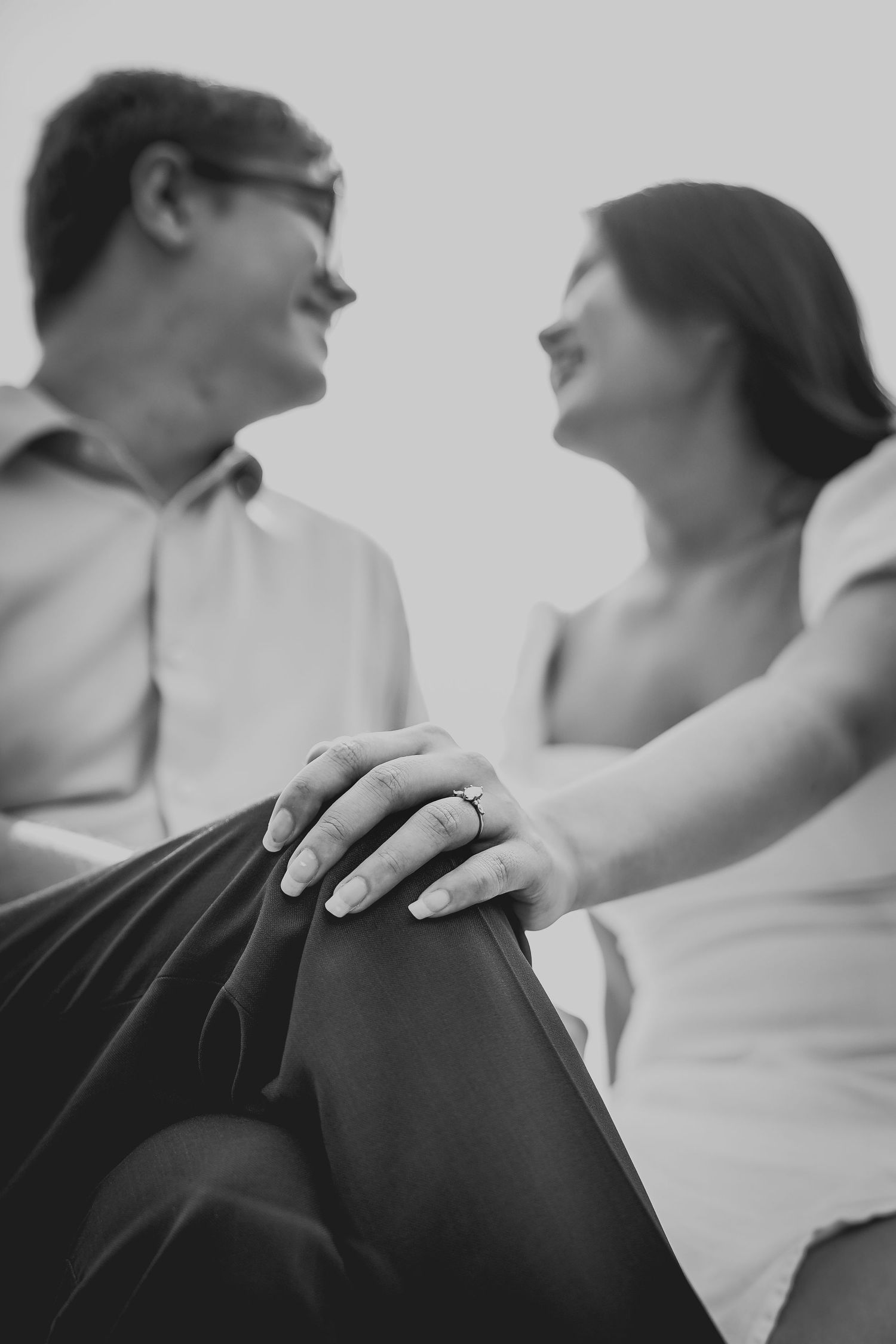 Artistic black and white close-up shots showing gentle physical connection between two people.