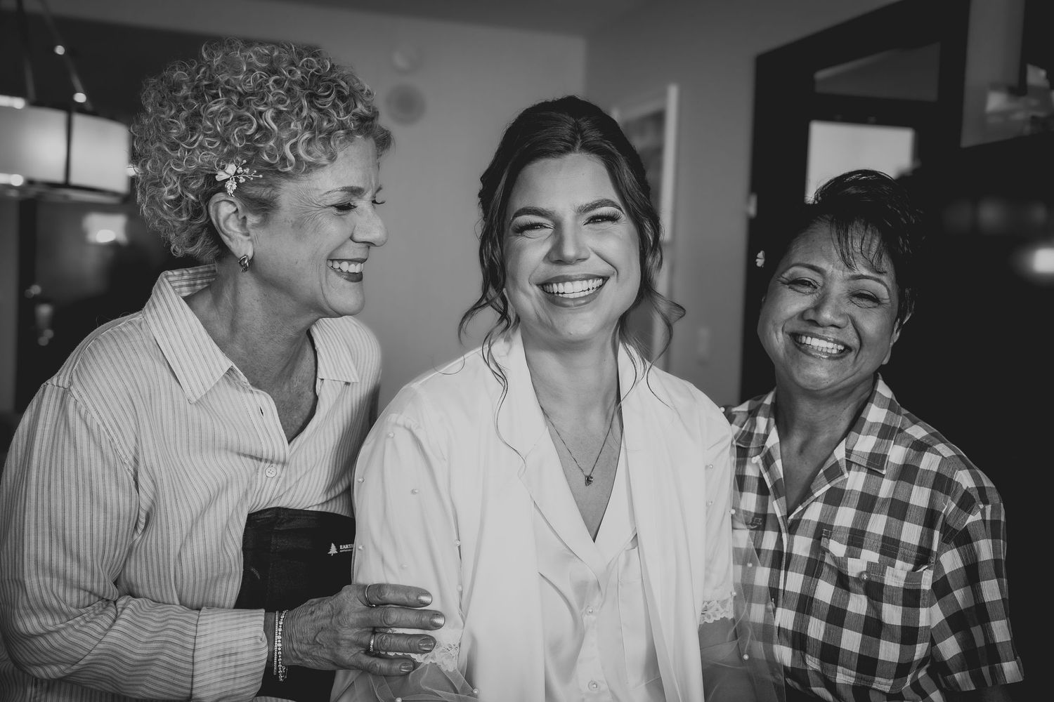 Family enjoying conversation and laughter in a casual indoor setting.