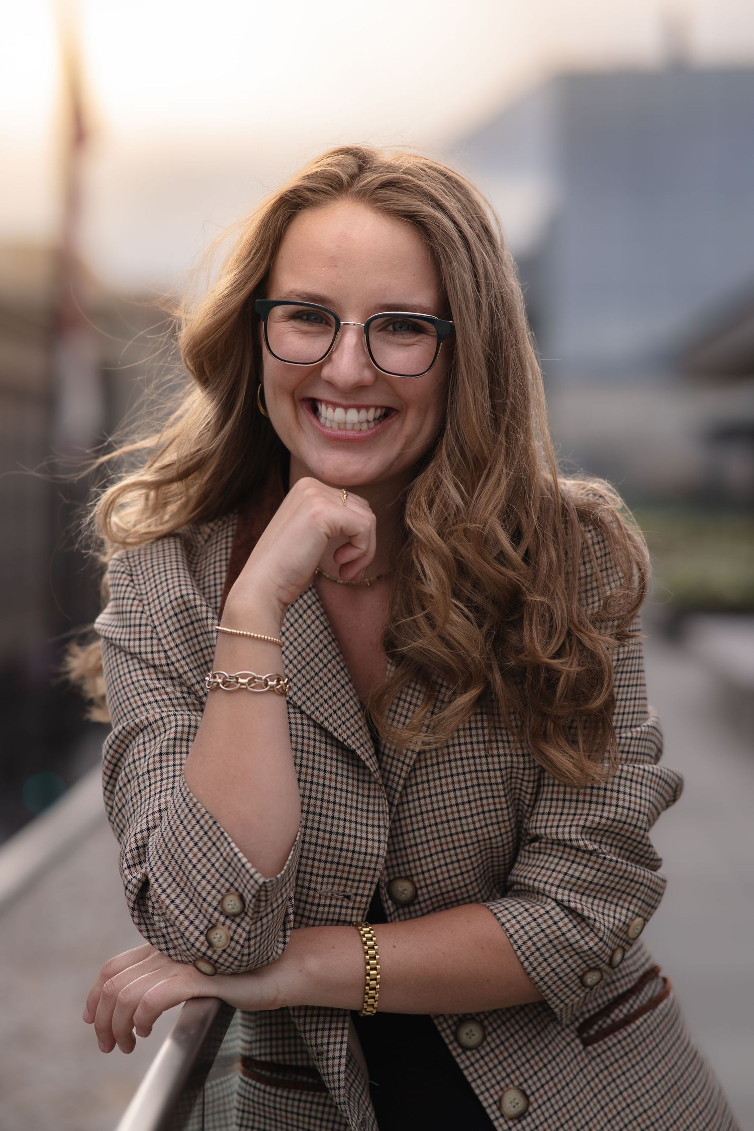 Portrait series featuring someone in a plaid blazer and glasses with soft natural lighting.