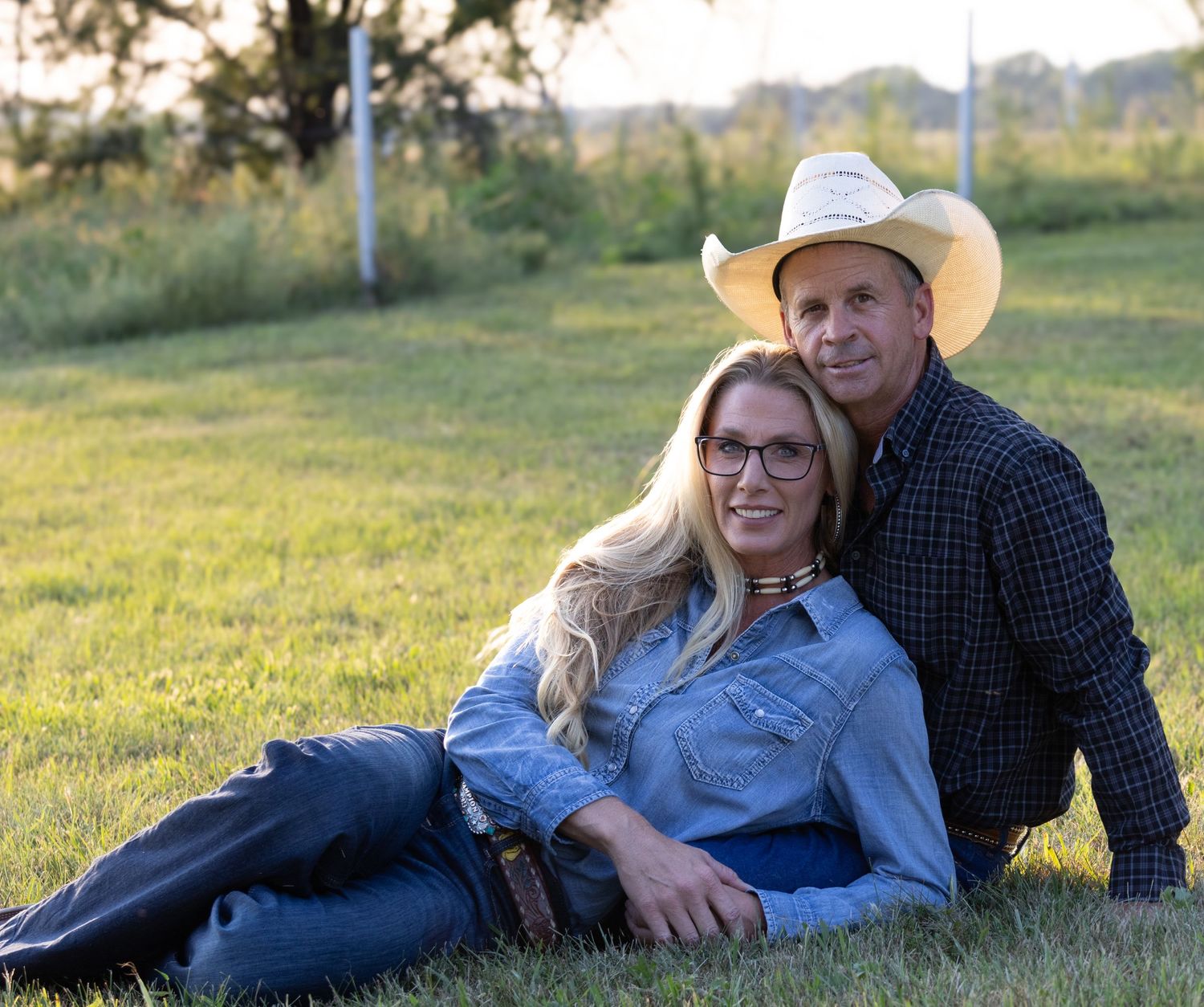 Western couple sharing laughs and enjoying the Nebraska sunset in their backyard.