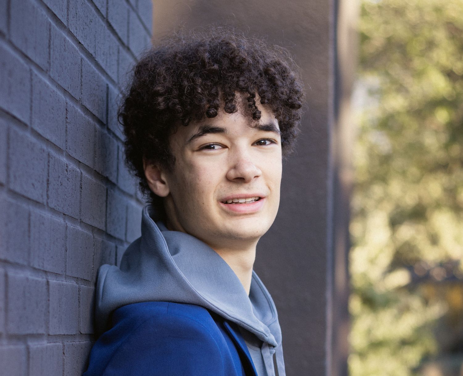 Senior portrait in Austin in Northwest Hills, casual outfit, natural smile.