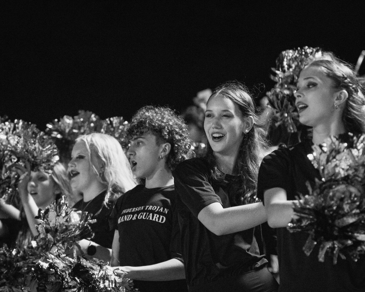 Candid photo of band students in stands during a football game in Austin, Texas.