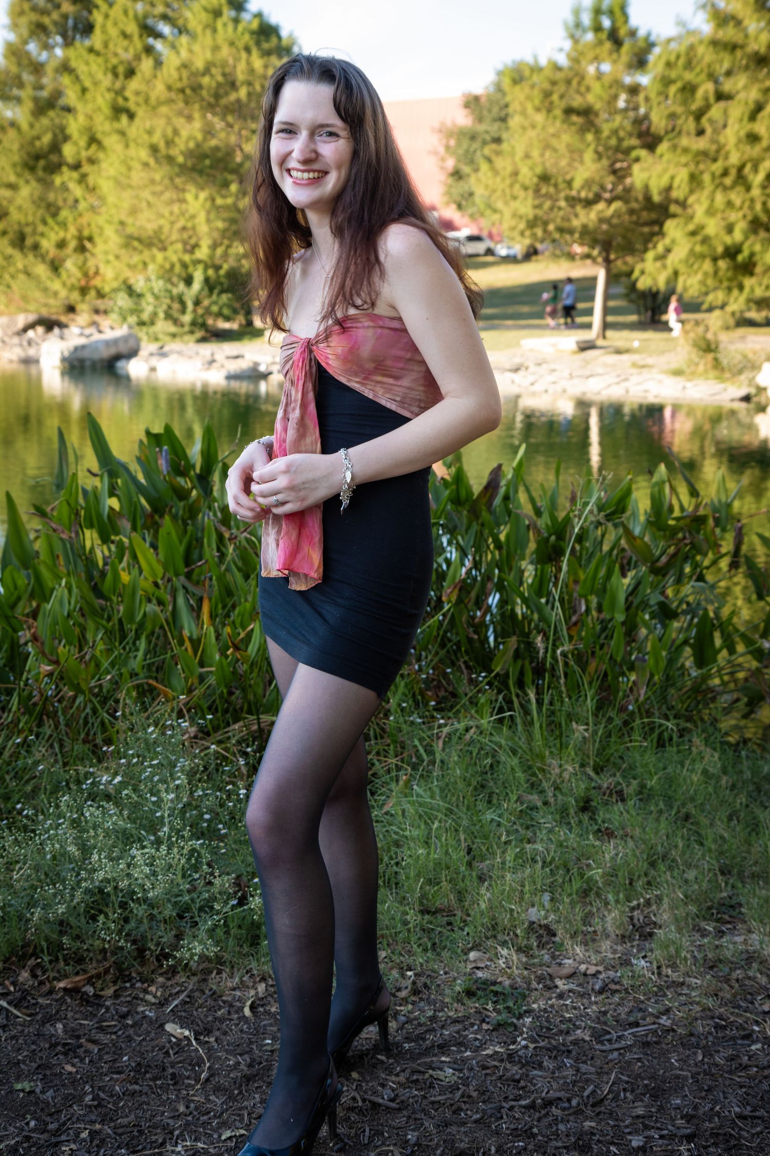 Senior portrait in Austin in Meuller, elevated look (dress), natural smile.