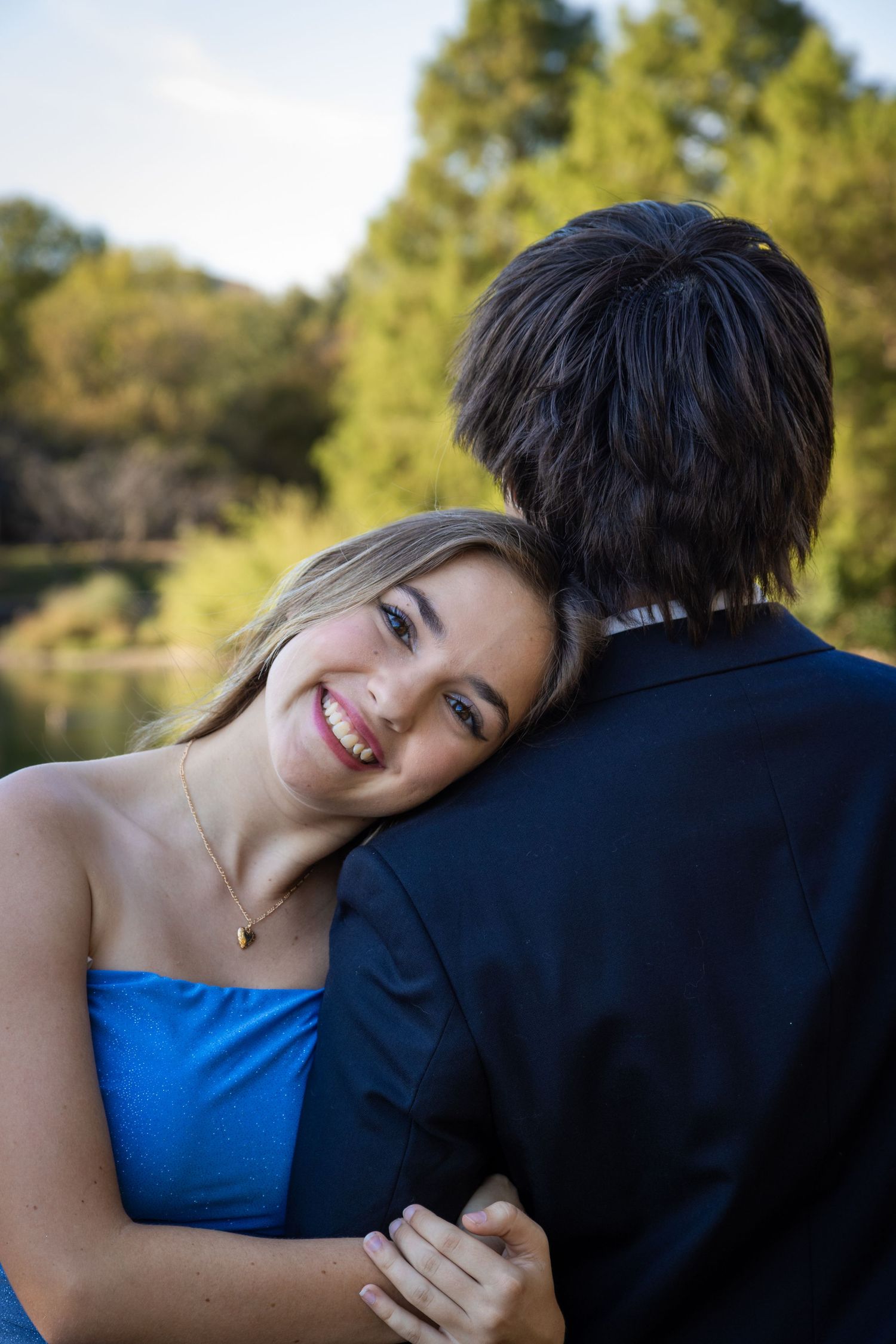 Senior portrait in Austin in Meuller, elevated look (dress), natural smile.