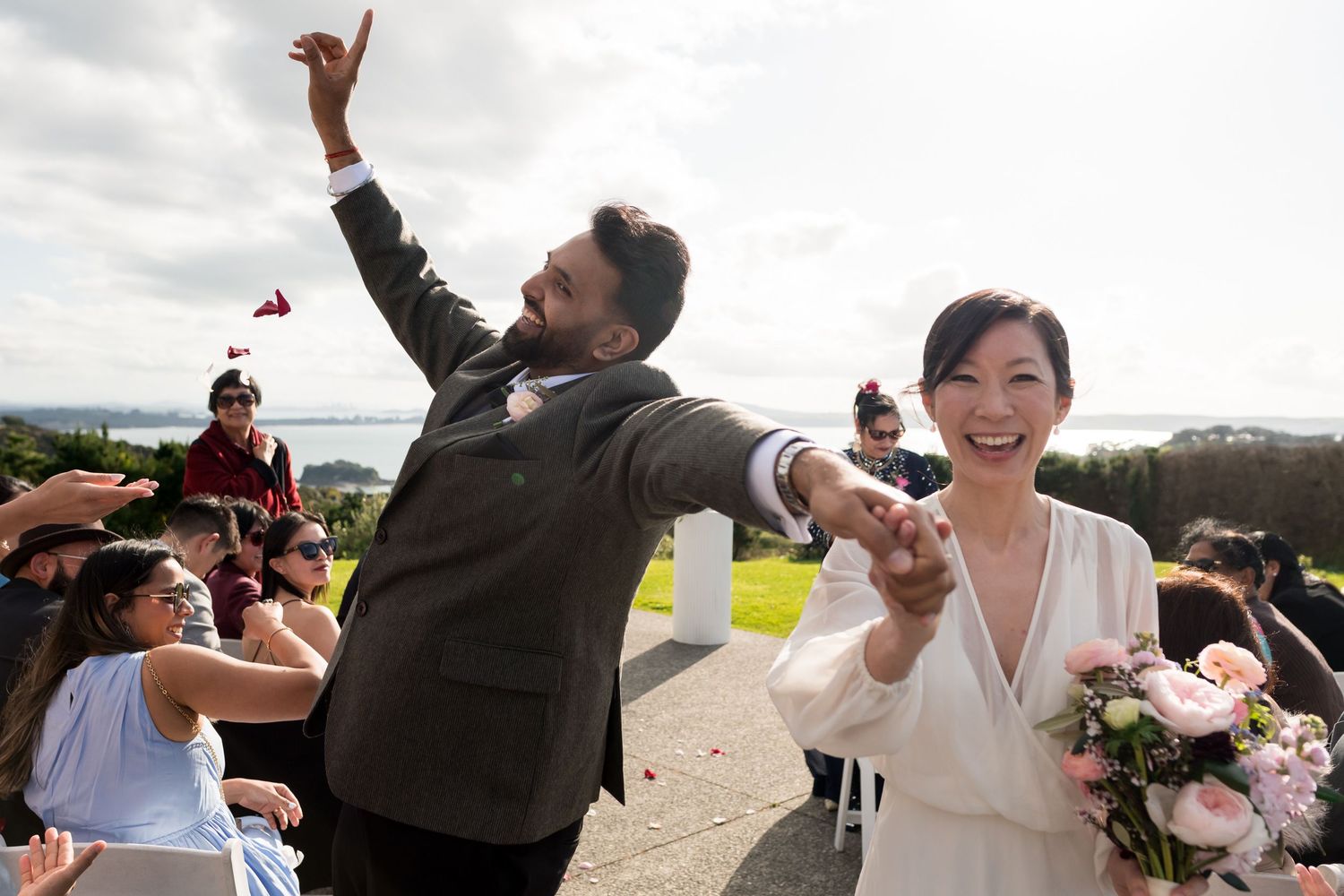 a bride and groom dance down the isle