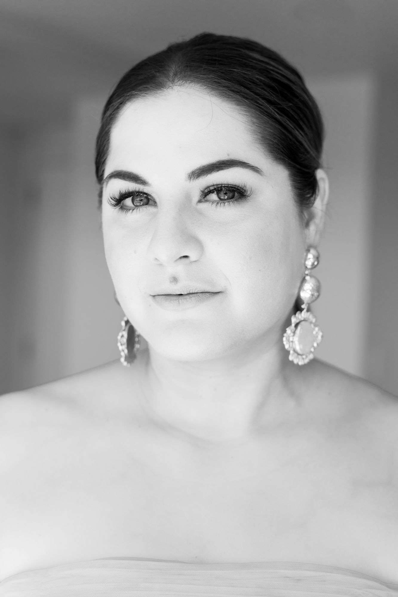 beautiful close up black and white portrait of a bride looking straight to the camera