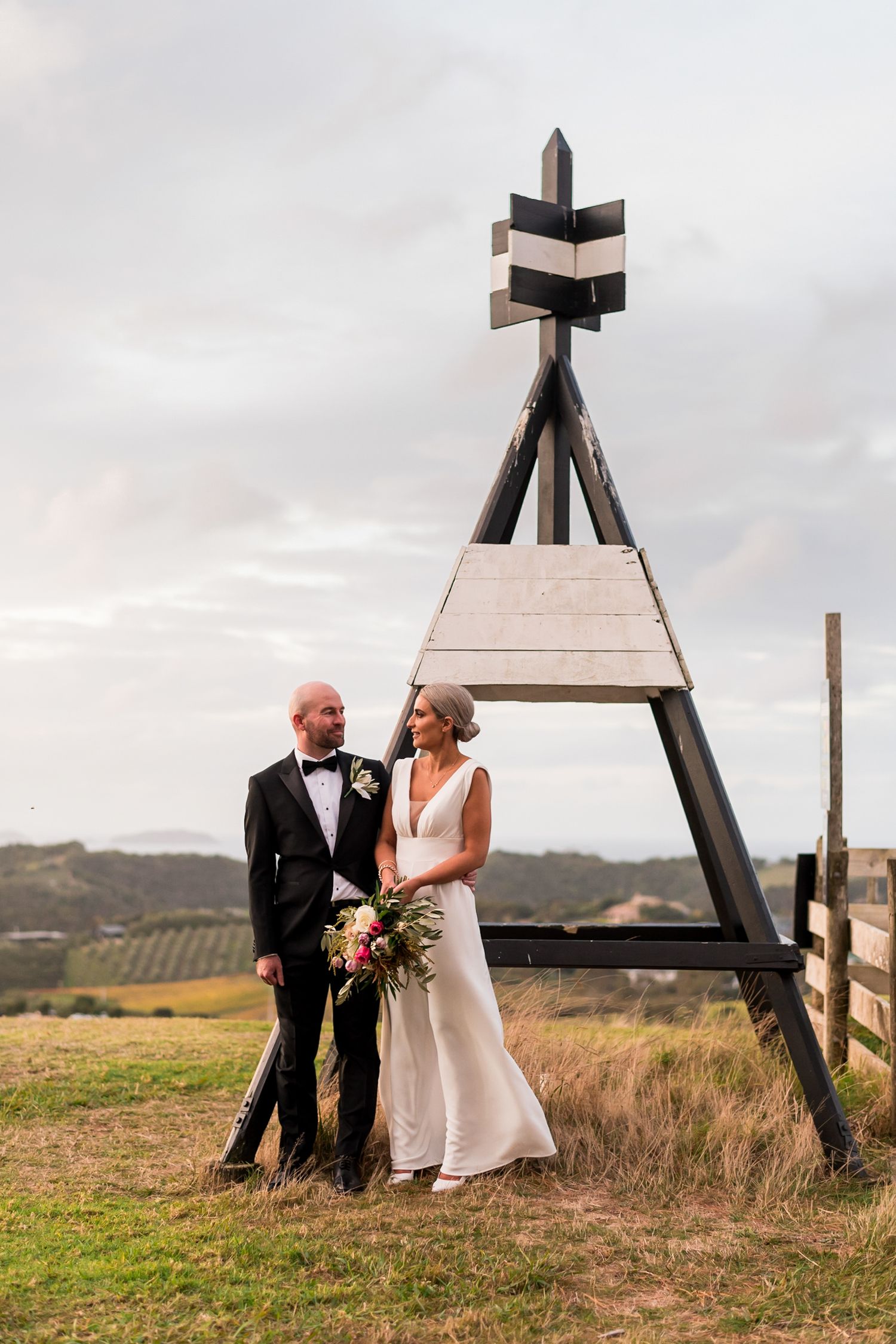 the trig is the focal point at the background of the bride and groom at the top of the Mudbrick hill