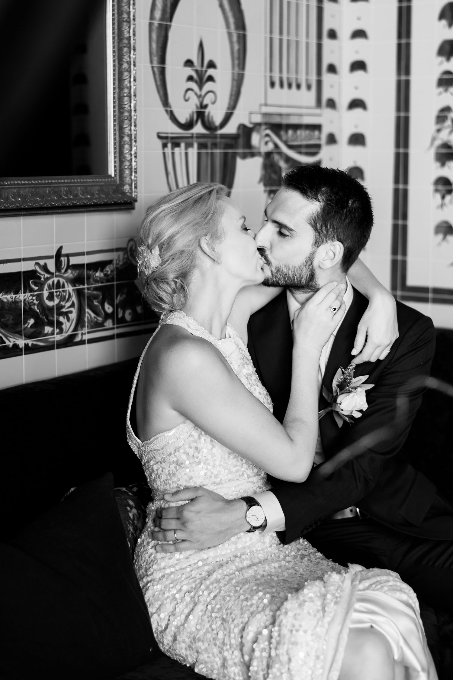 an intimate black and white image of a bride and groom embracing with emotion not aware of the camera at Tantalus