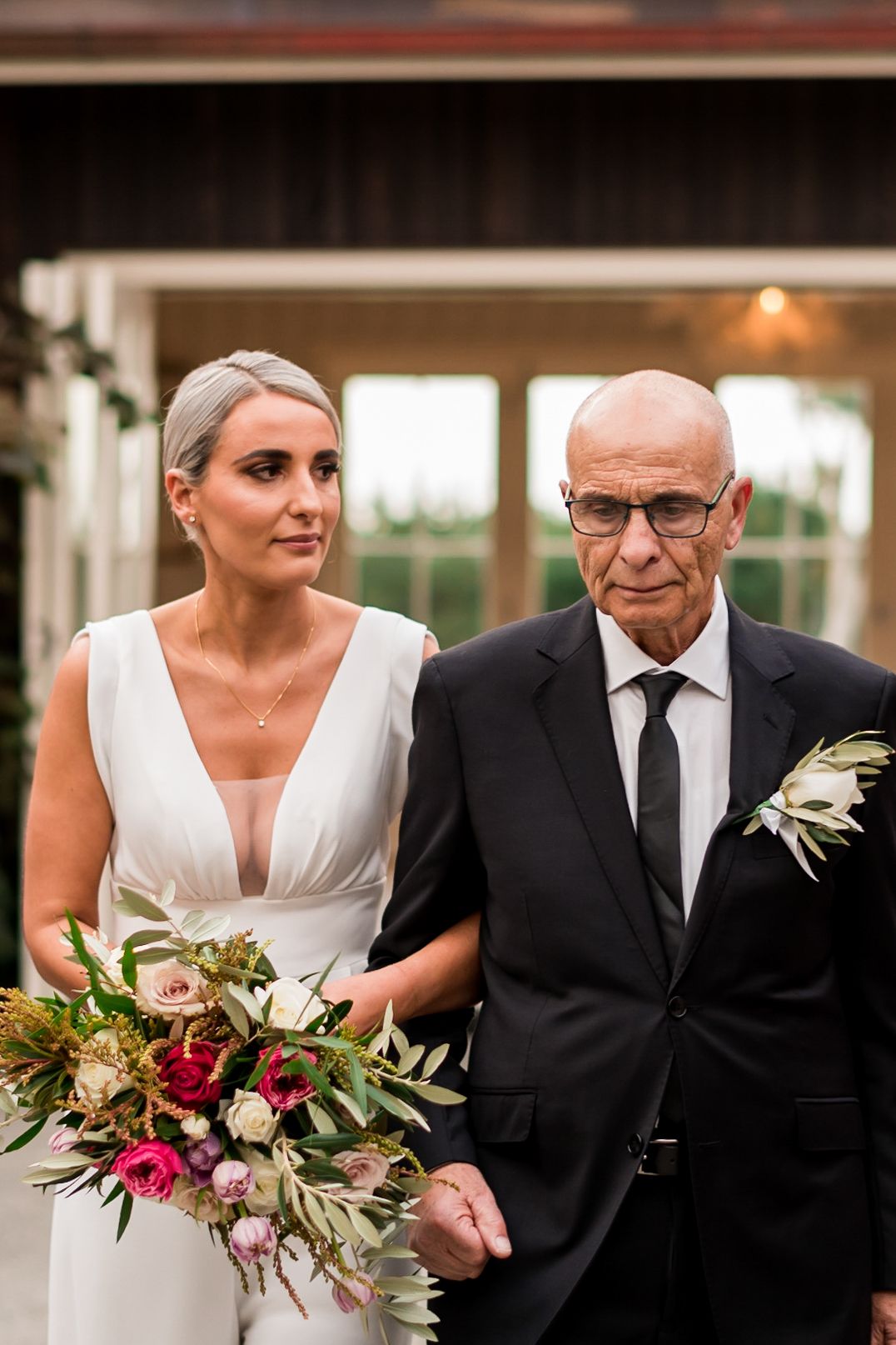 a father walks his daughter down the isle at Mudbrick