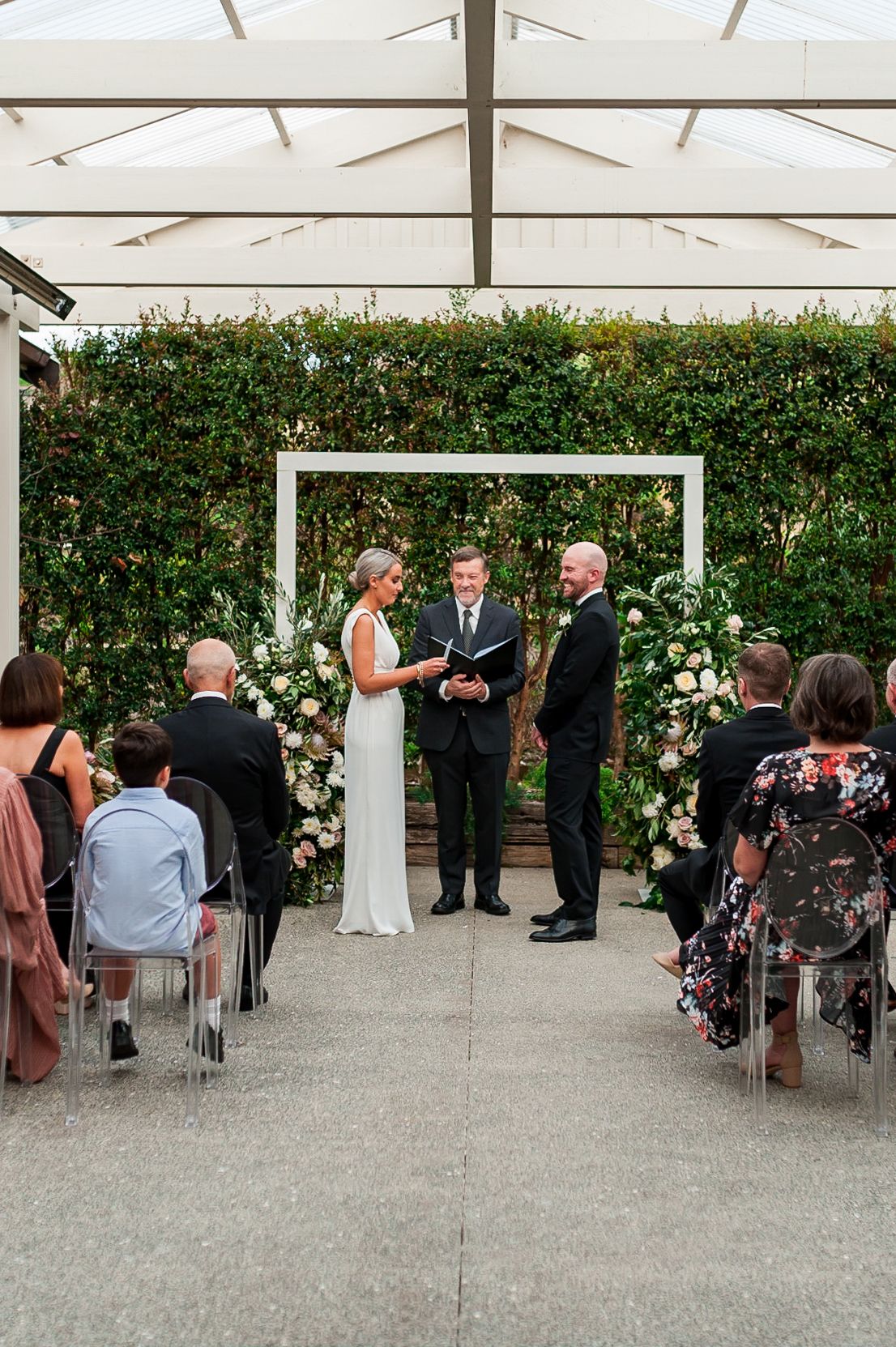 the ceremony of a bride and groom getting married at Mudbrick