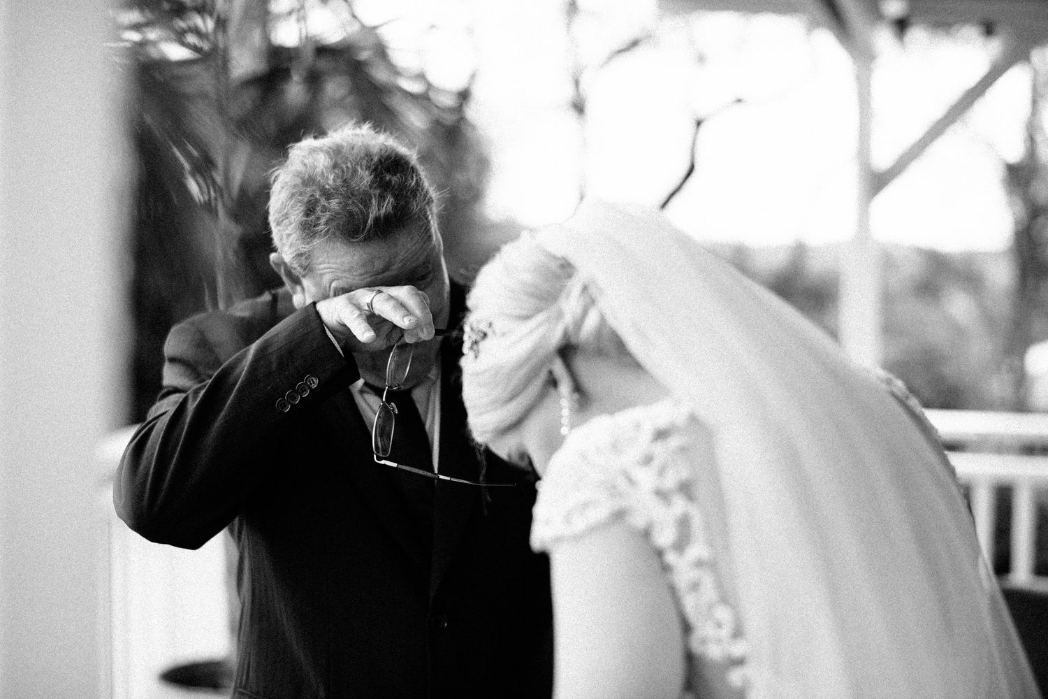 In this black and white image a father breaks down and cried on seeing his daughter dressed for her wedding day