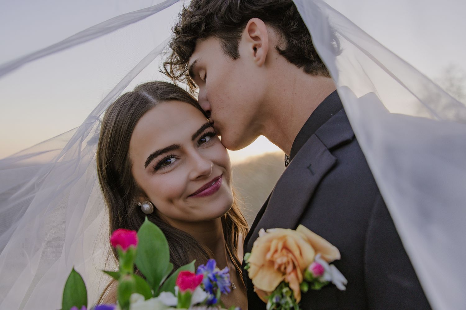 A romantic wedding photo series showing a couple embracing outdoors with colorful floral bouquet details.