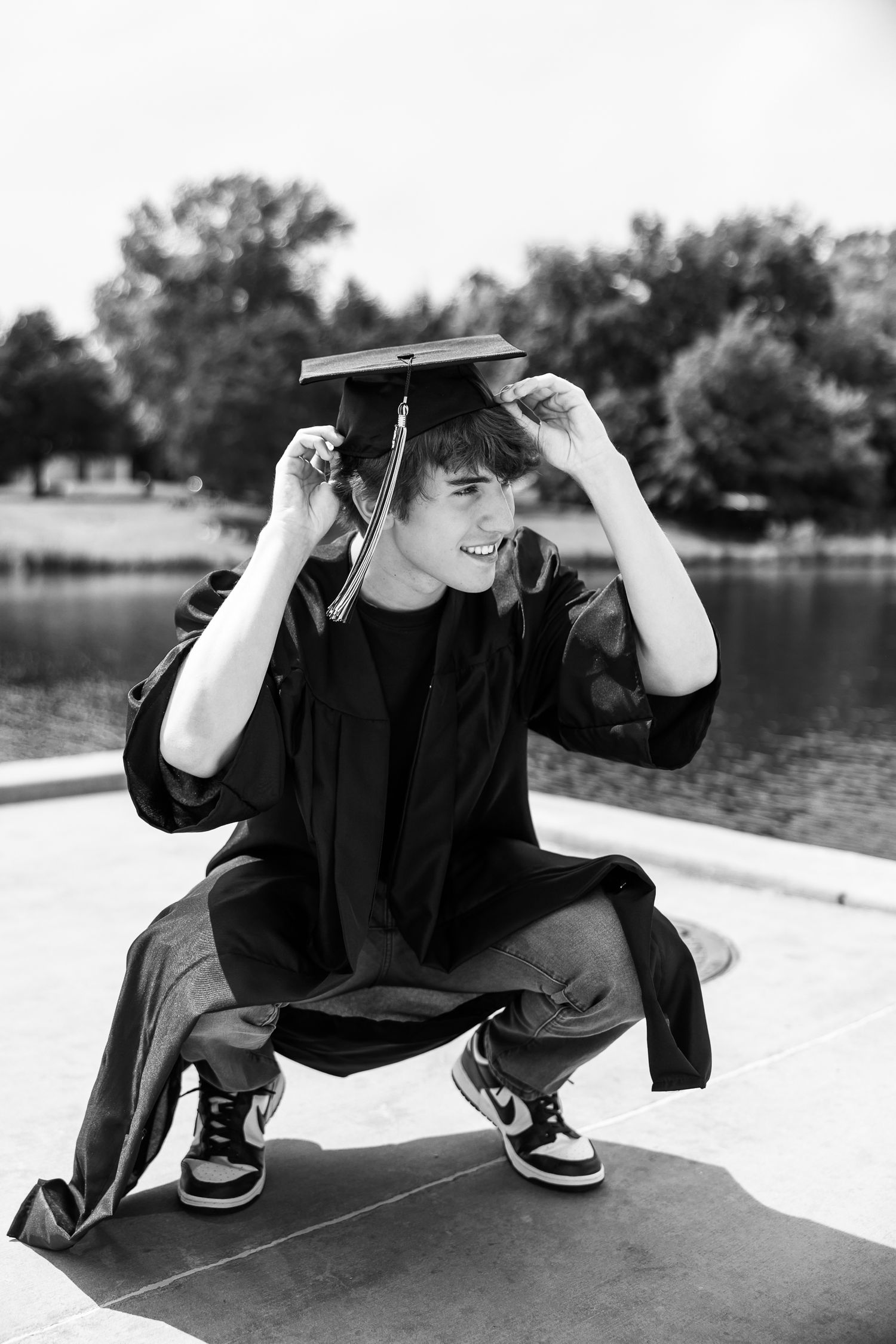 Black and white sequence showing a person in dark clothing performing a dynamic crouching movement.