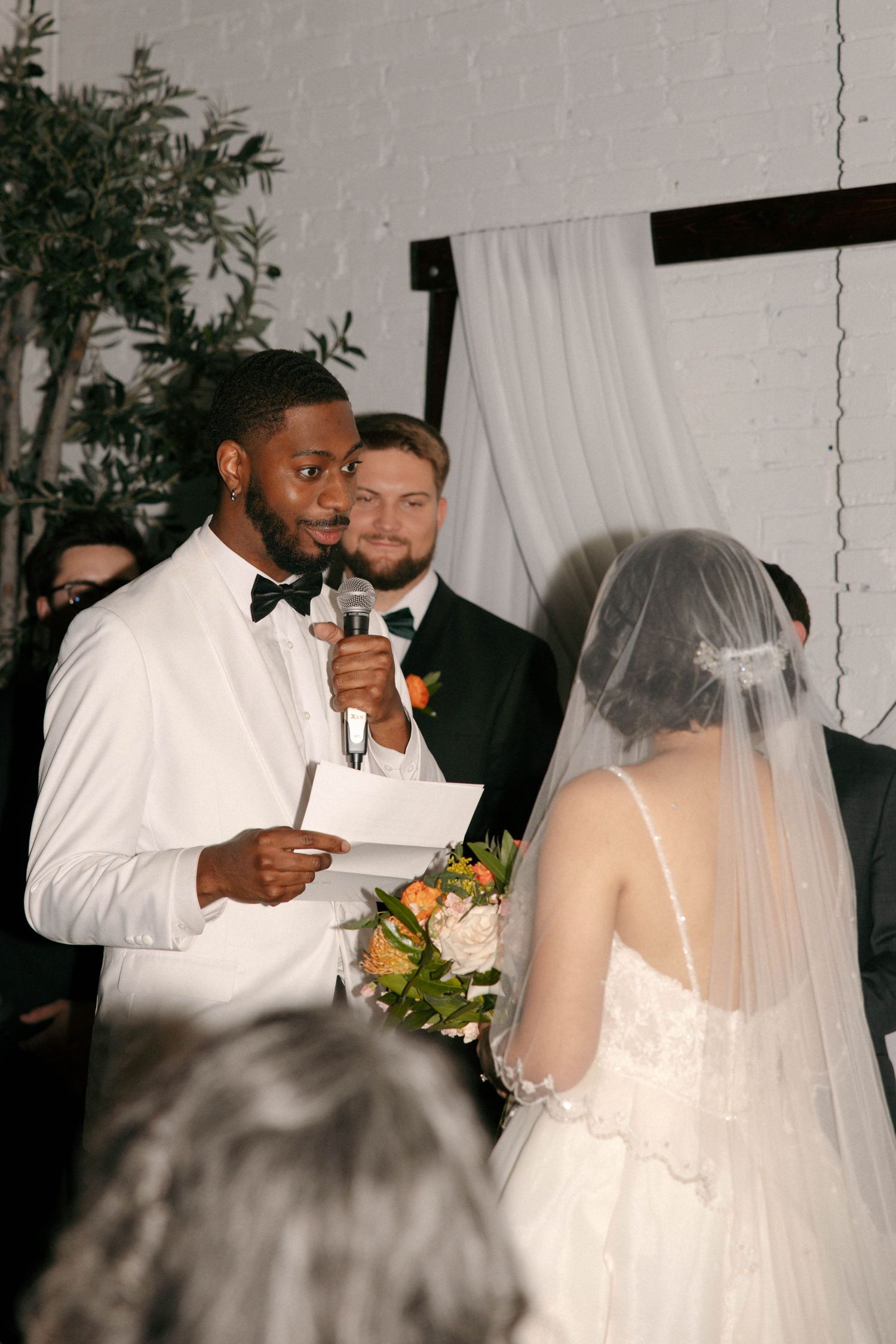 Wedding ceremony candid moments captured in black and white with elegant decor.