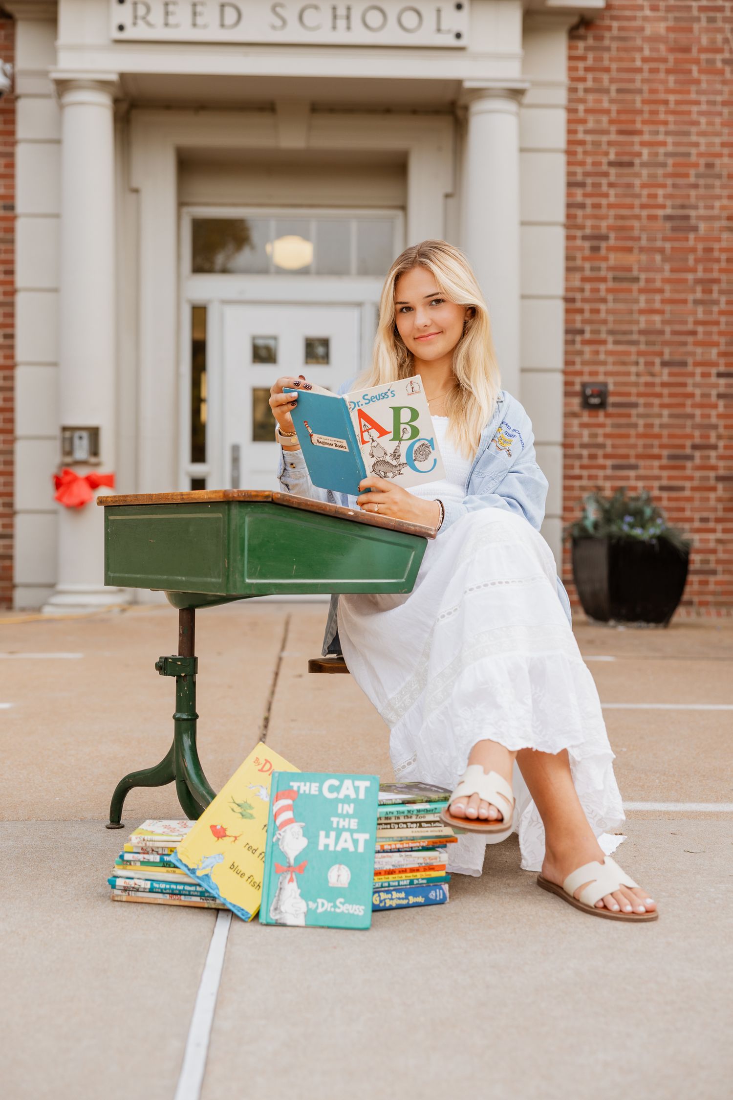 Dr. Seuss books and other children's classics arranged outside historic Reed School entrance.