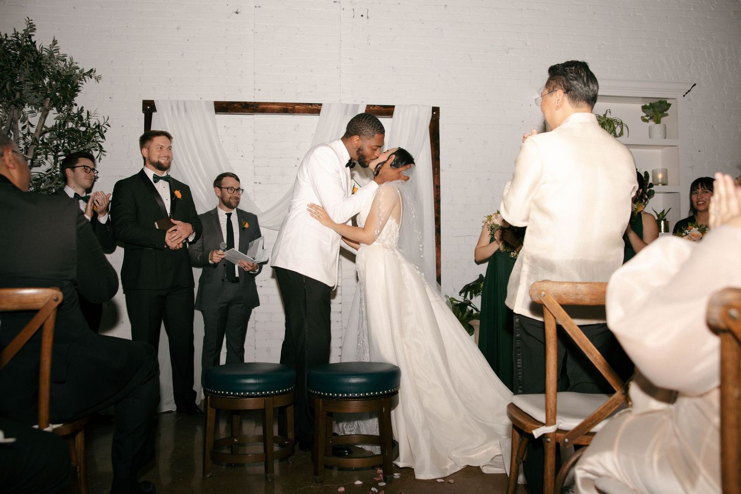 Joyful wedding reception moment with dancing and celebration indoors.