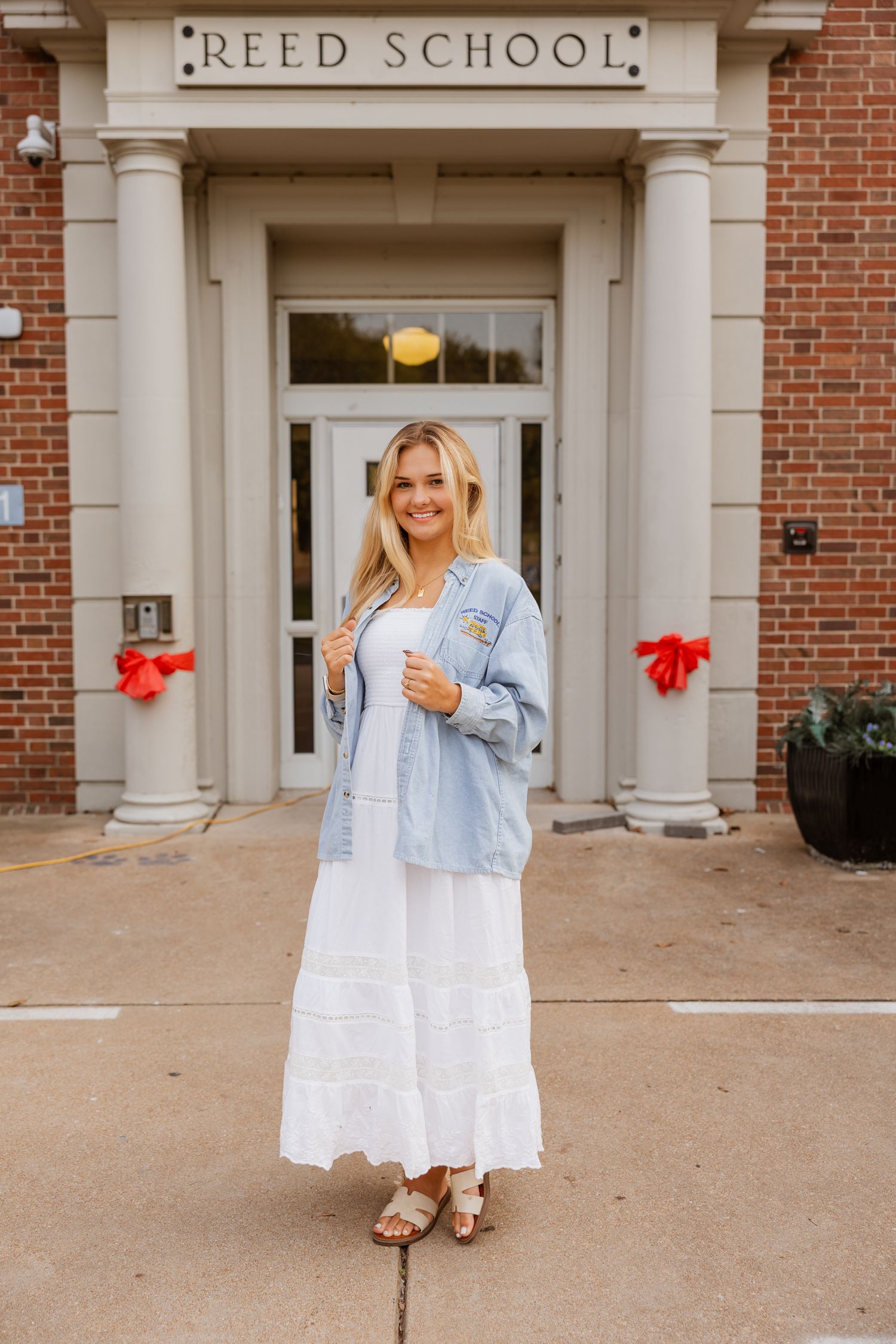 Fashion photo series in front of Reed School showing white dress and jean jacket combination.