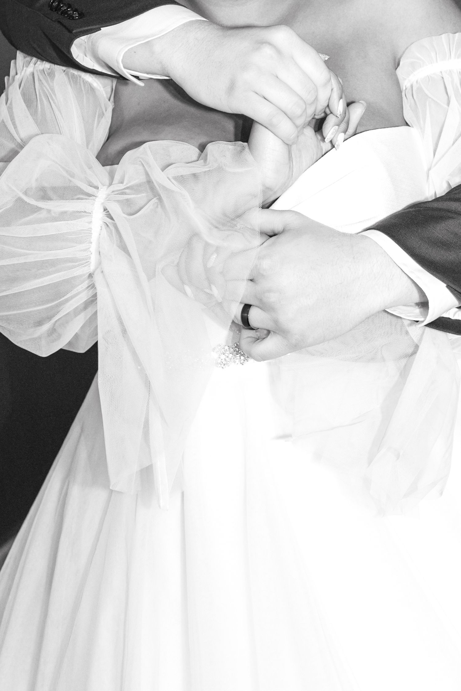 Black and white detail shot of wedding dress buttons and lace.
