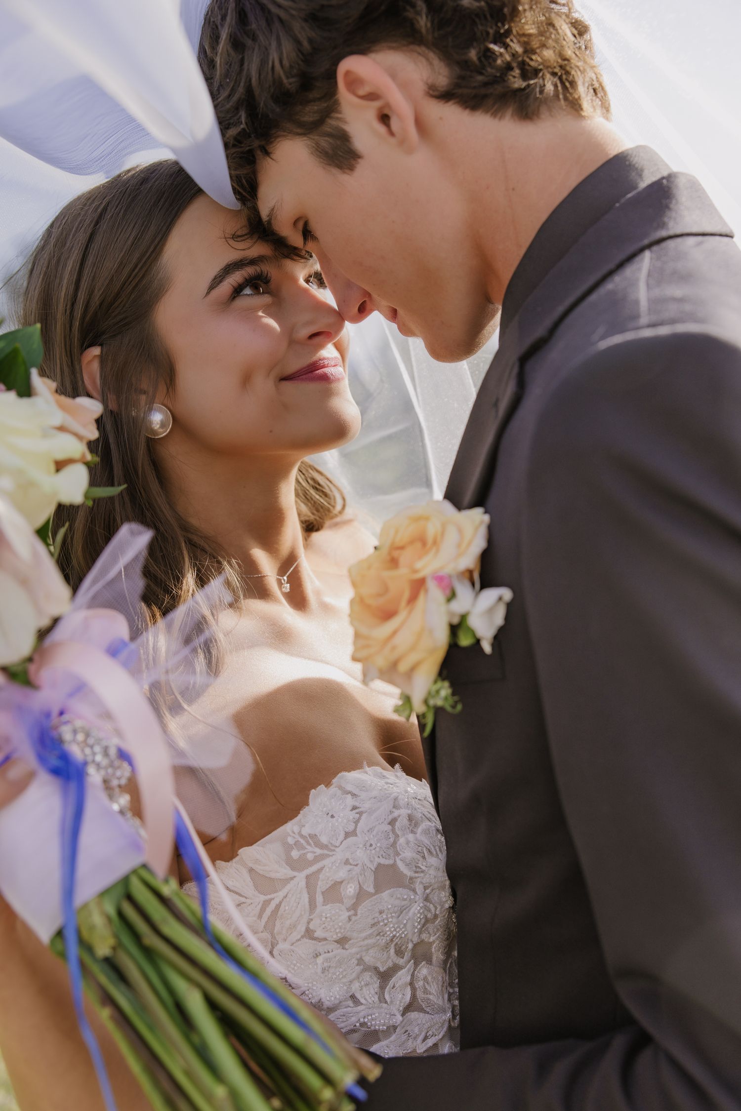 Romantic wedding sequence showing bride in lace dress and groom sharing tender moments outdoors.