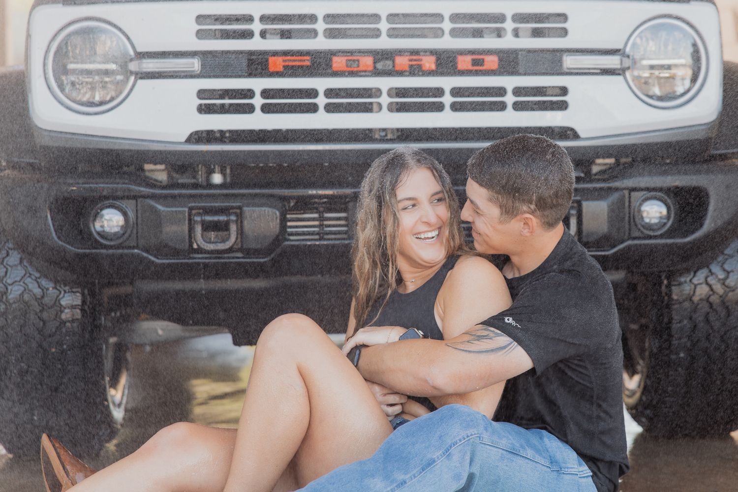 Series of intimate poses in front of classic truck grille during couple's photoshoot.