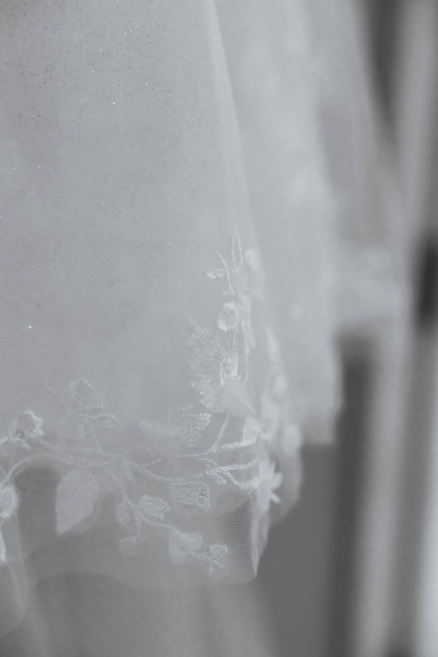 Ethereal white smoke wisps create an artistic pattern against a dark background.