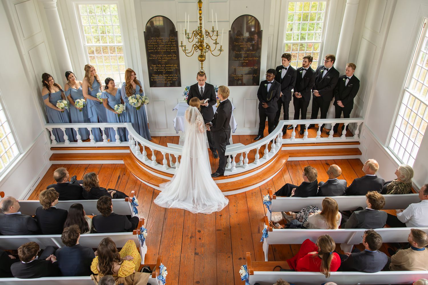 Interior shots of a traditional church wedding ceremony with white walls and wooden pews.