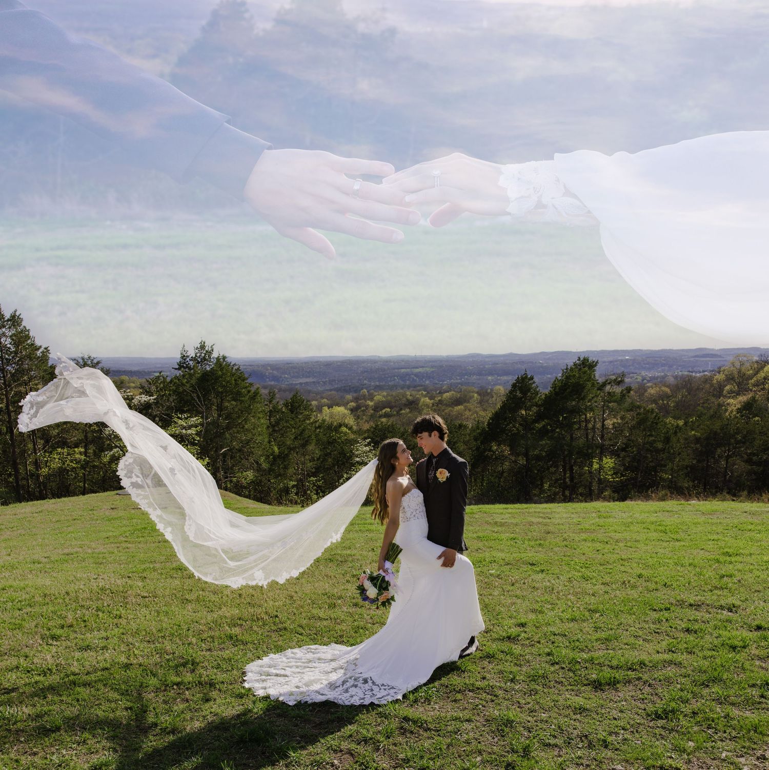 Wedding veil flowing dramatically in the wind against a mountain landscape backdrop.