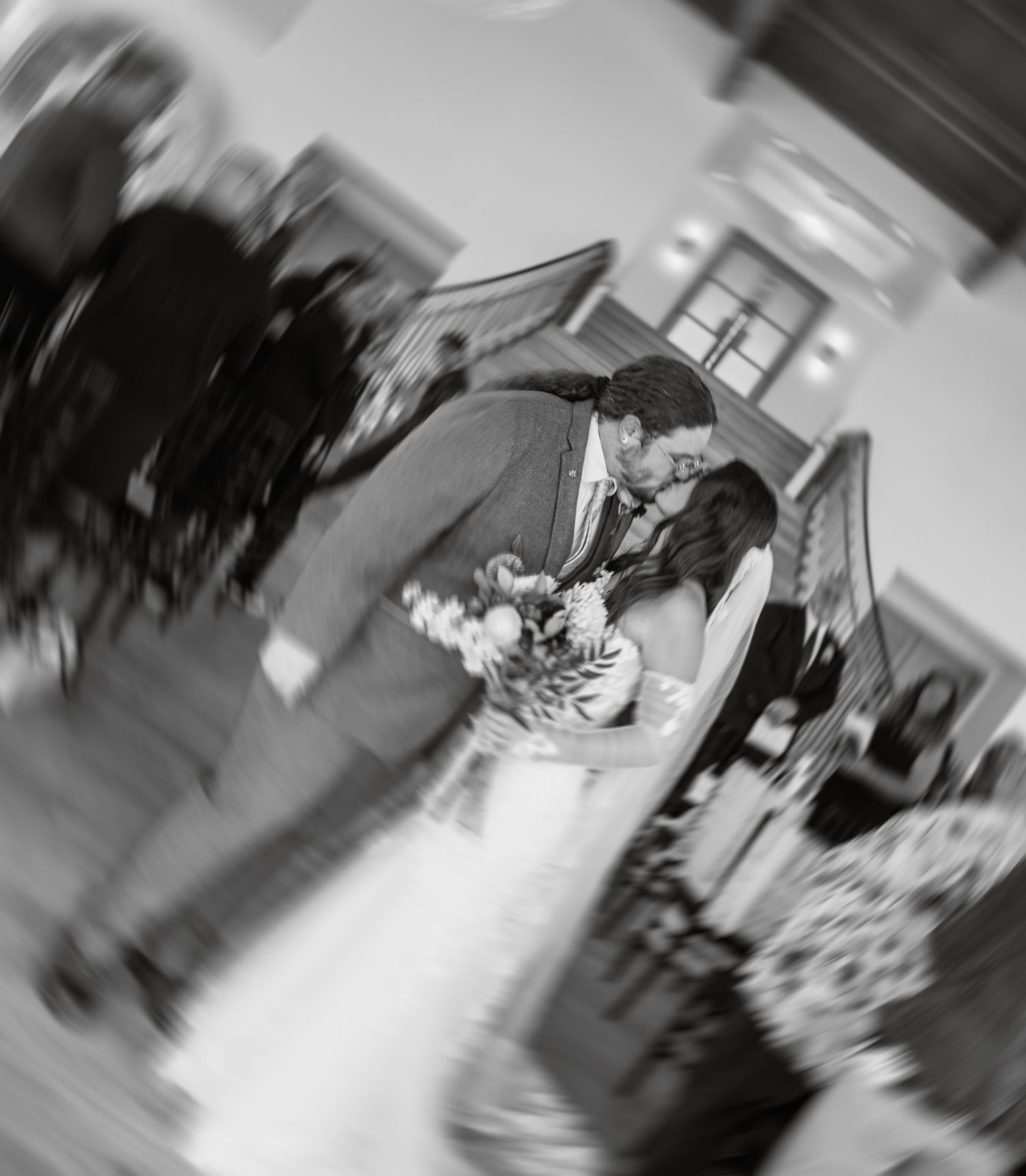 Artistic black and white motion blur capture of wedding ceremony moments.