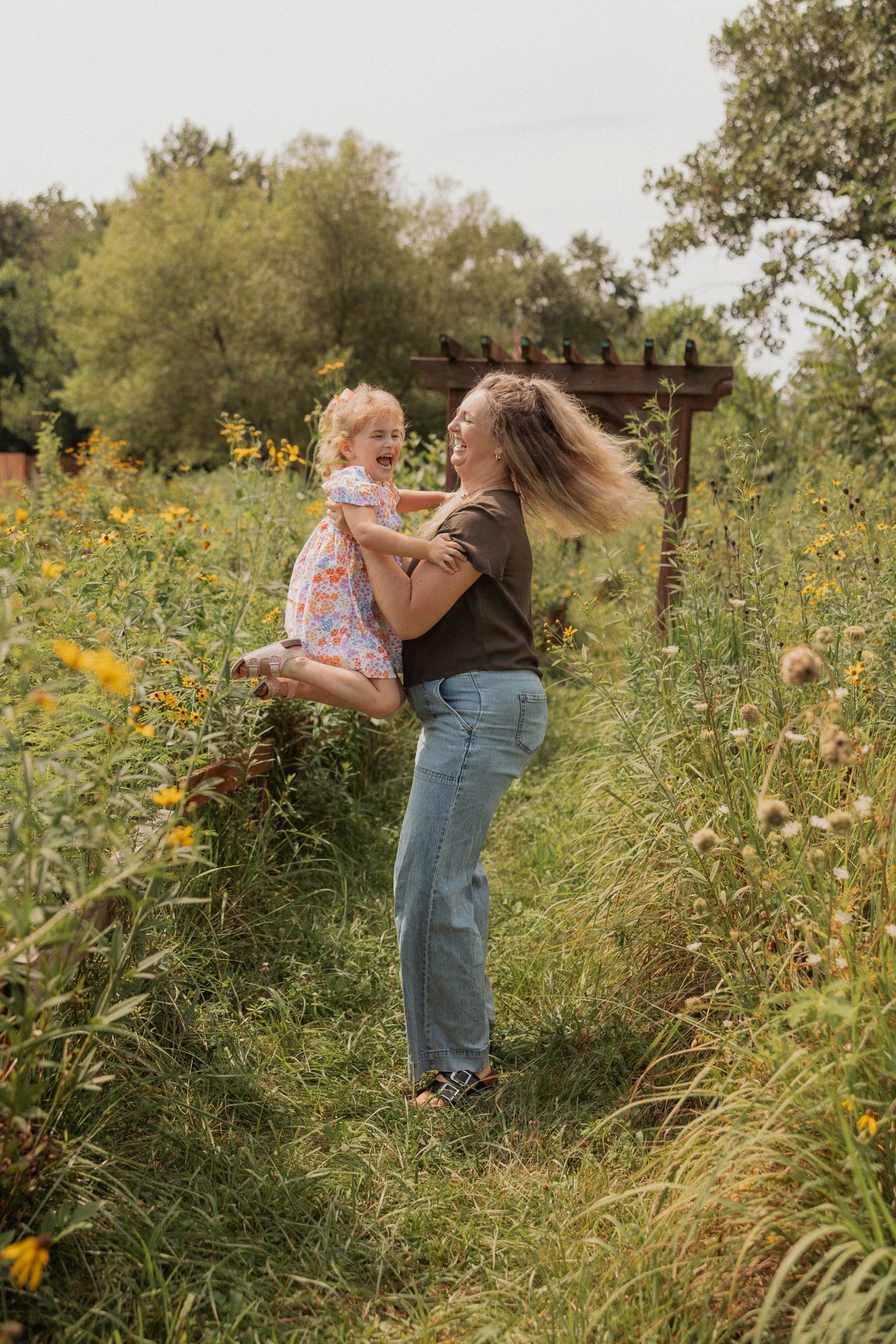 Playful interactions photographed in a wildflower field with yellow blooms.